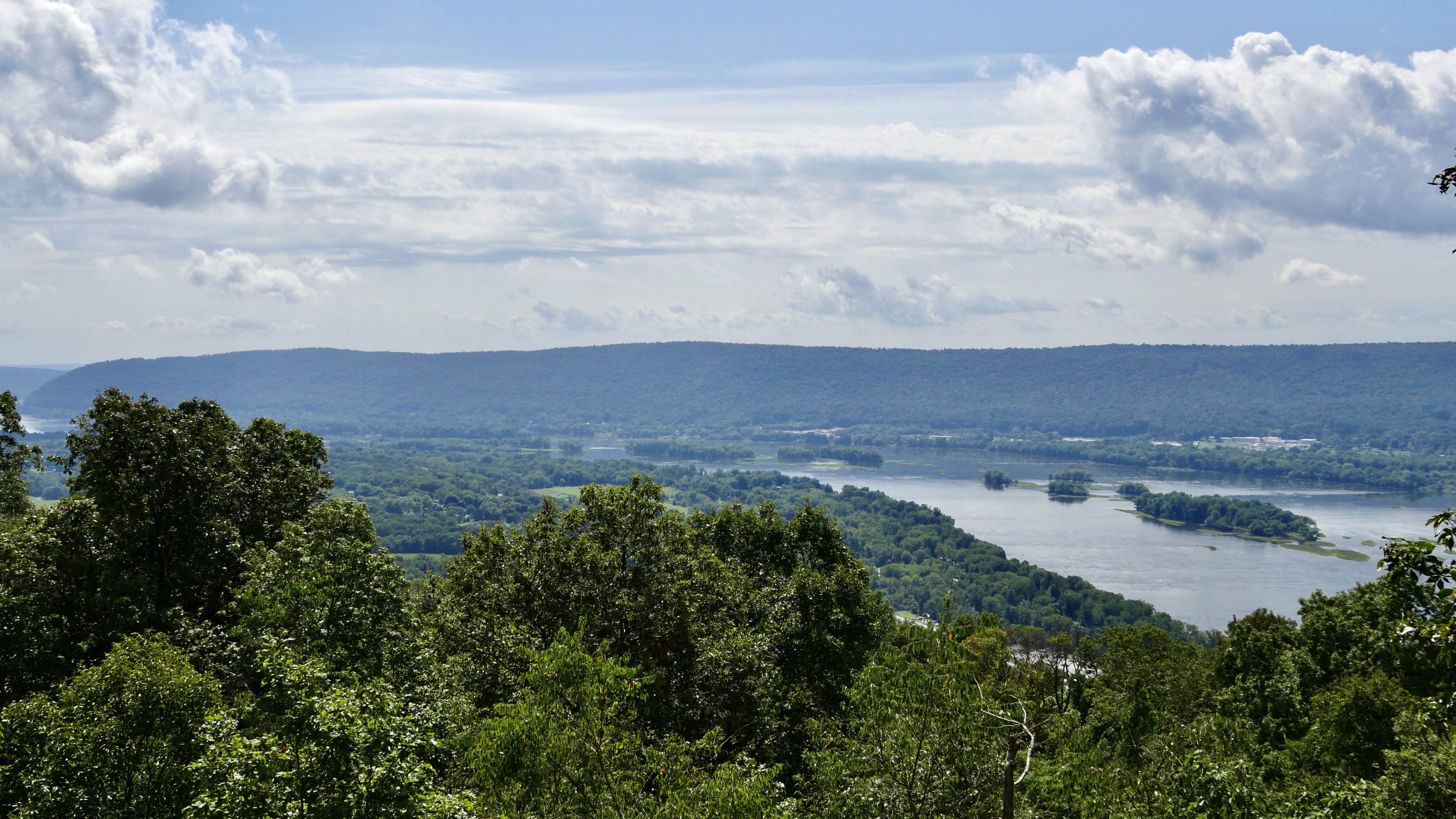 Scenic view from the Appalachian Trail. The wide, smooth Susquehanna River flows below the vantage point curving to the left towards the Hamer Woodlands at Cove Mountain ridge line.