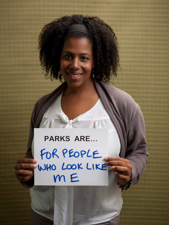 Rue Mapp portrait. She holds a sign saying 'Parks are for people who look like me.'