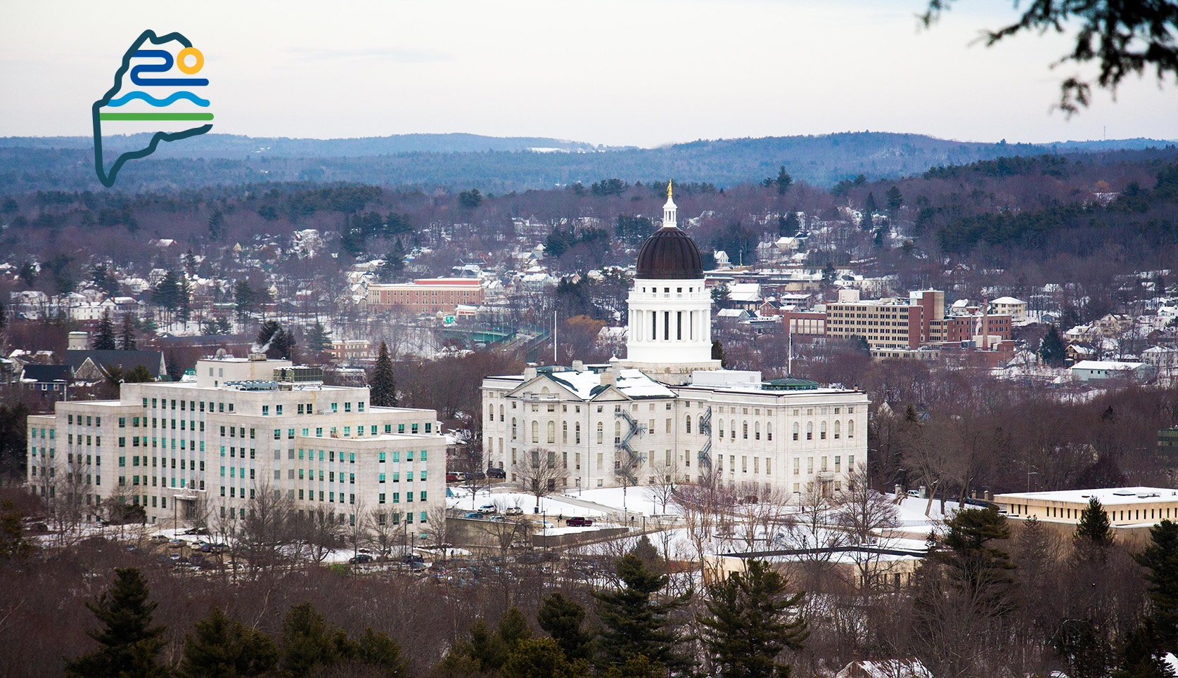 A view of the Maine statehouse from a surrounding hill.