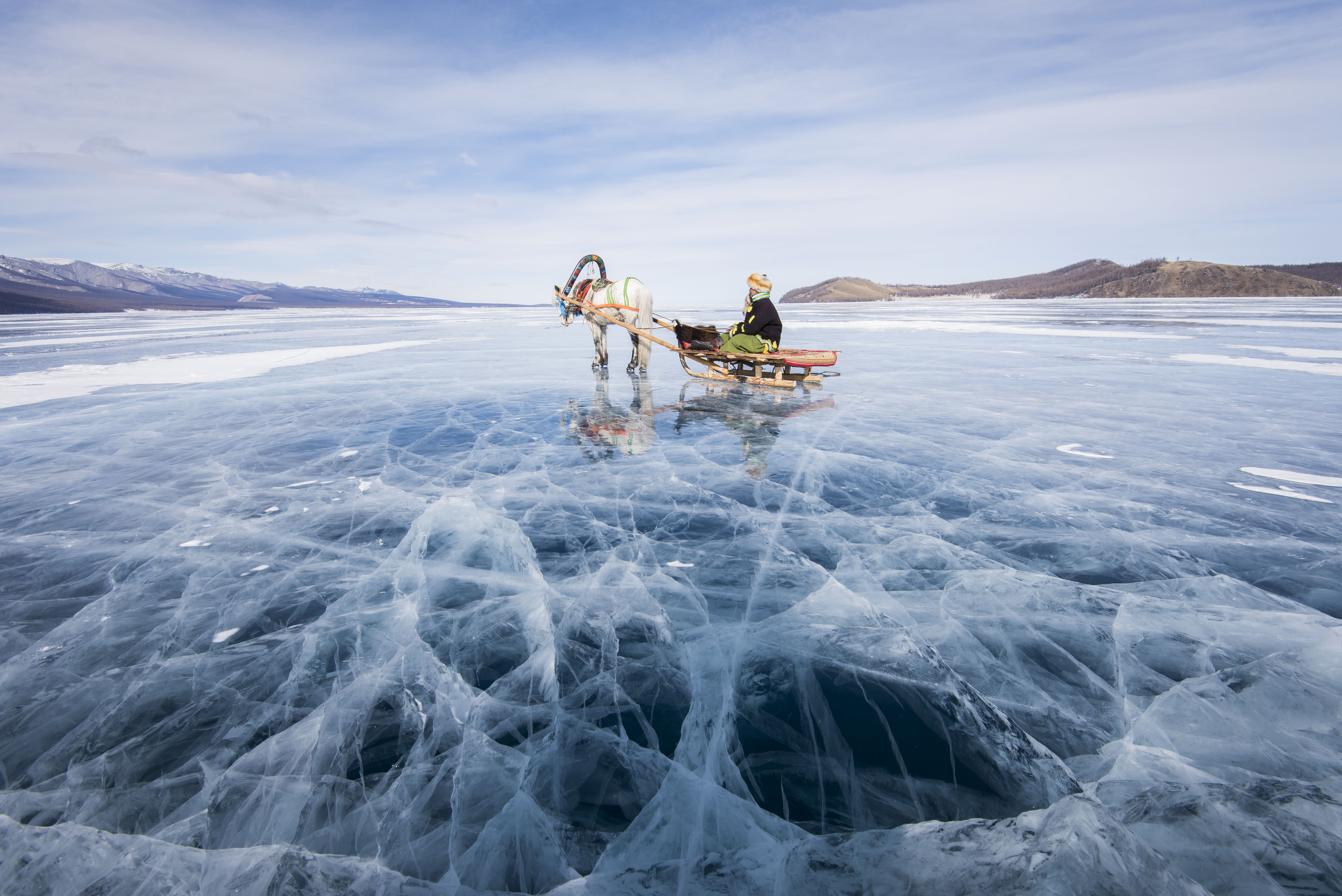 A reindeer pulls a sled on Mongolia’s massive Lake Hövsgöl