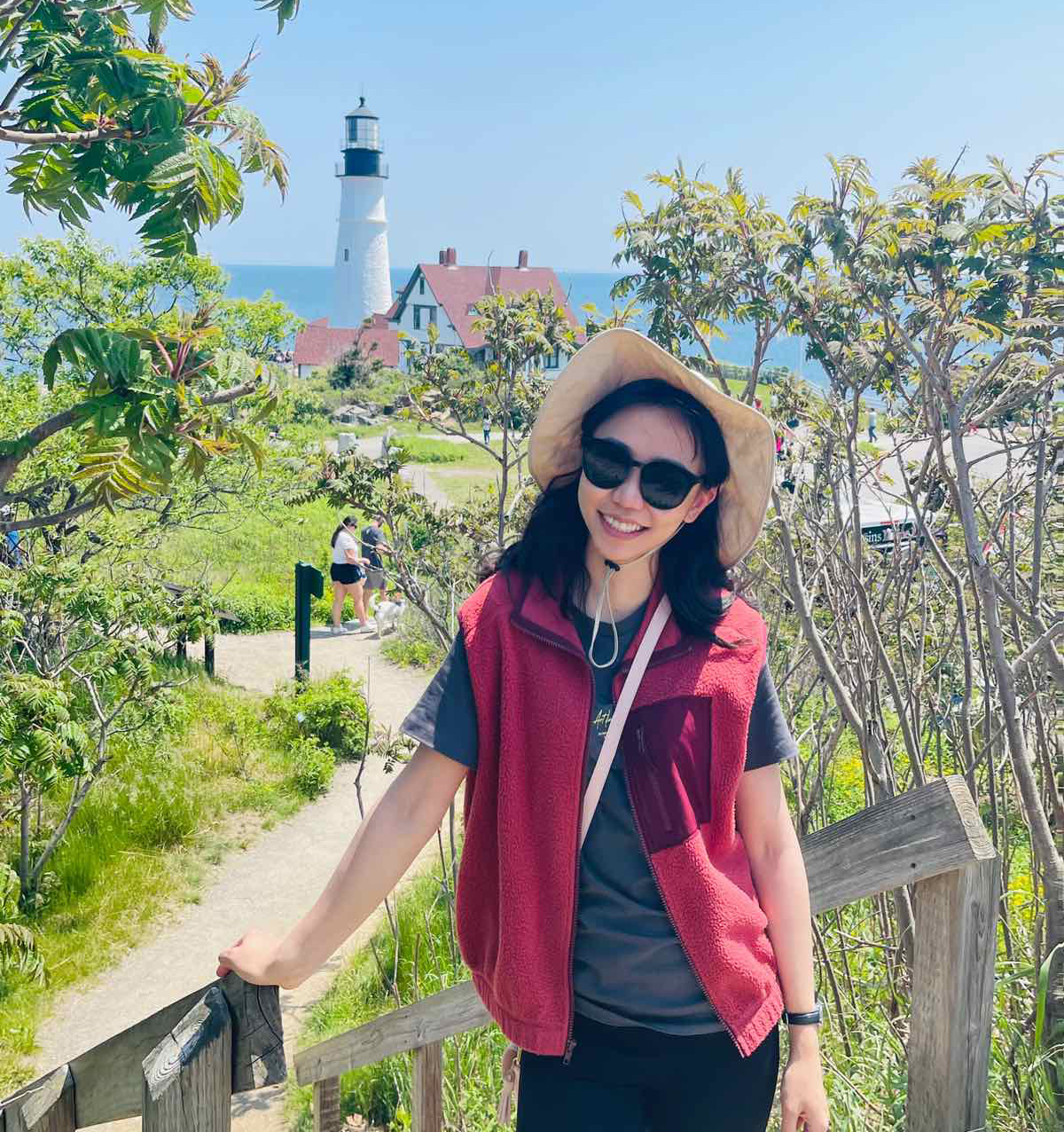 Marla Ganbat poses in front of a Maine lighthouse.