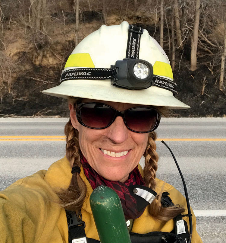 Woman wearing controlled burn gear.