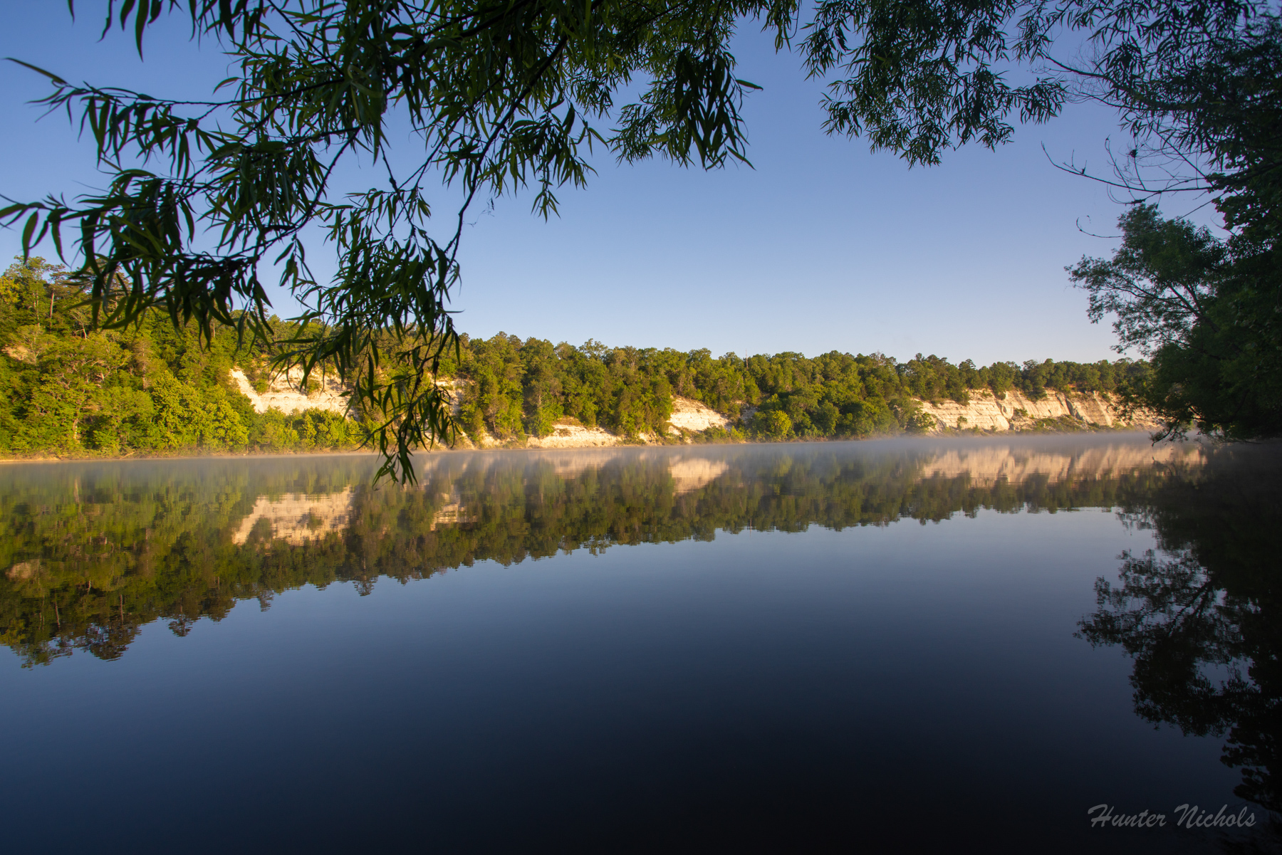 Gold and white colored bluffs and ravines line the Alabama River. 