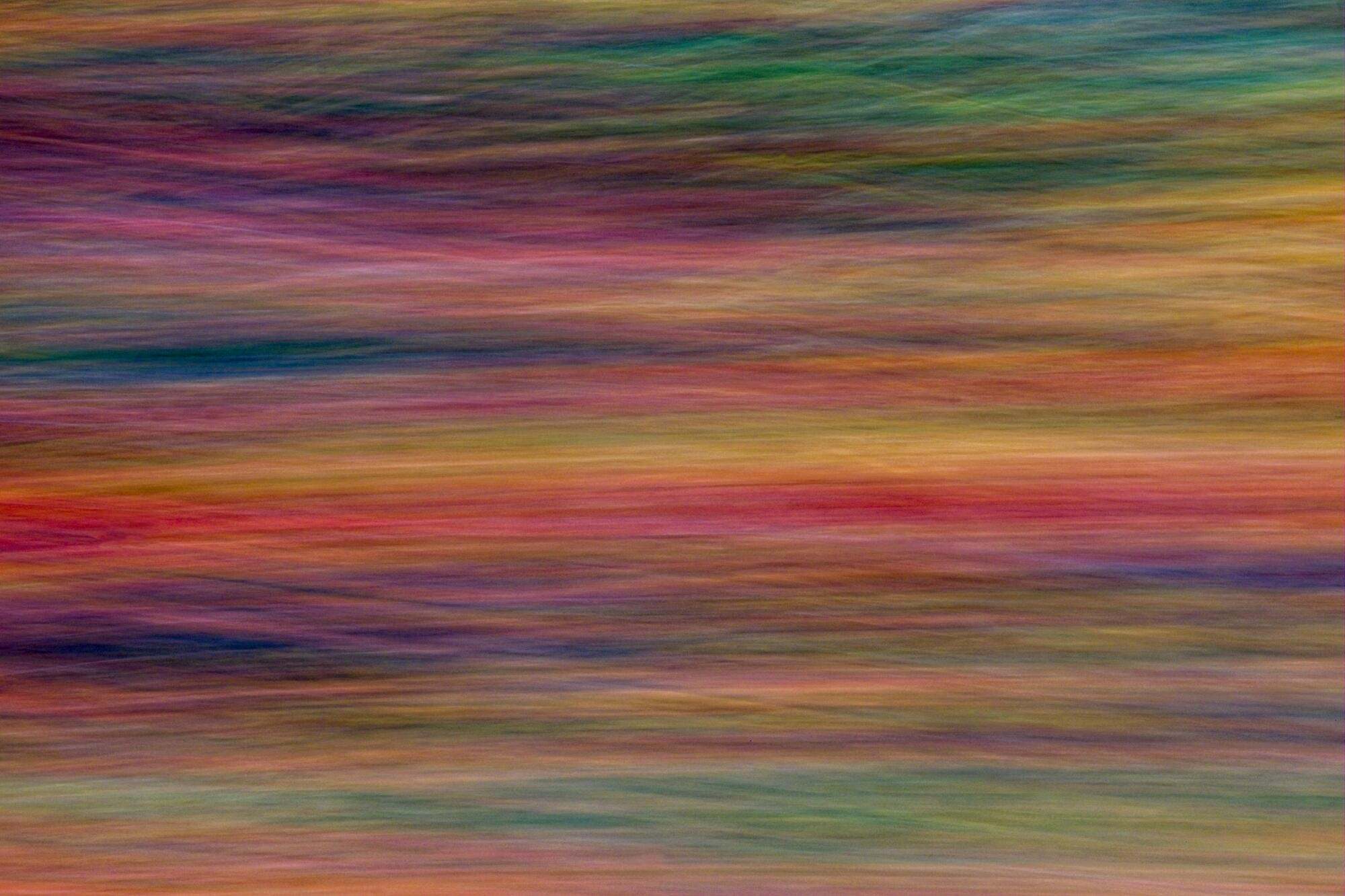 A horizontal blur of multiple colors.