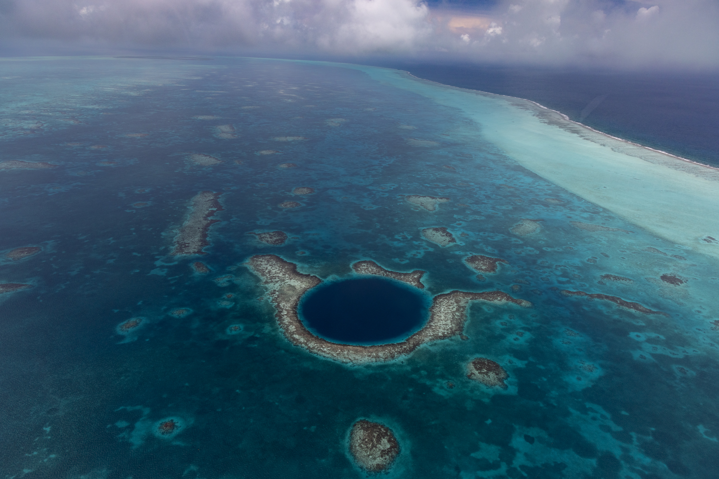 The Great Blue Hole is a circle of darker blue off the coast of Belize.