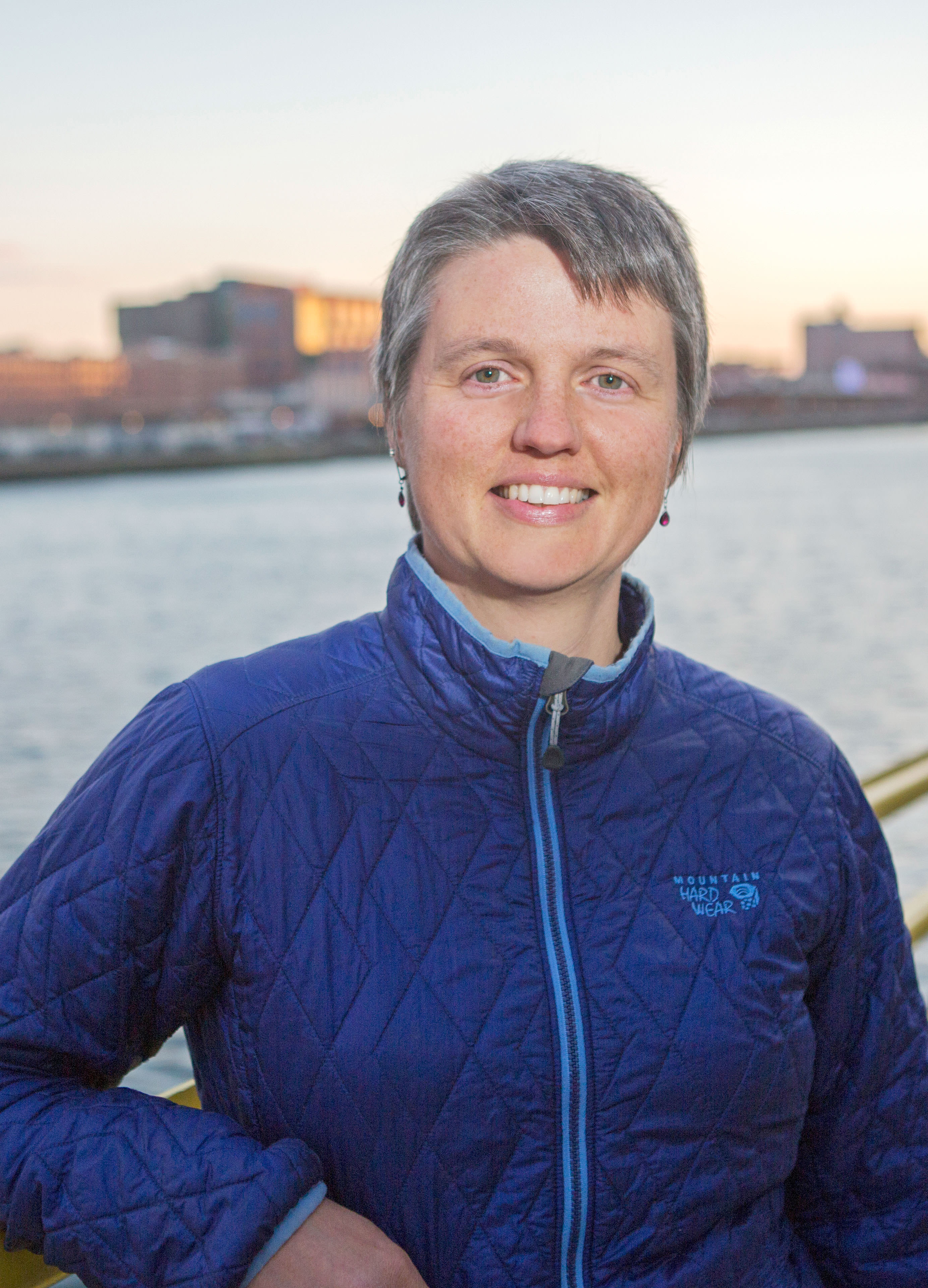 Headshot of Alison Bowden with the ocean out of focus in the background. 