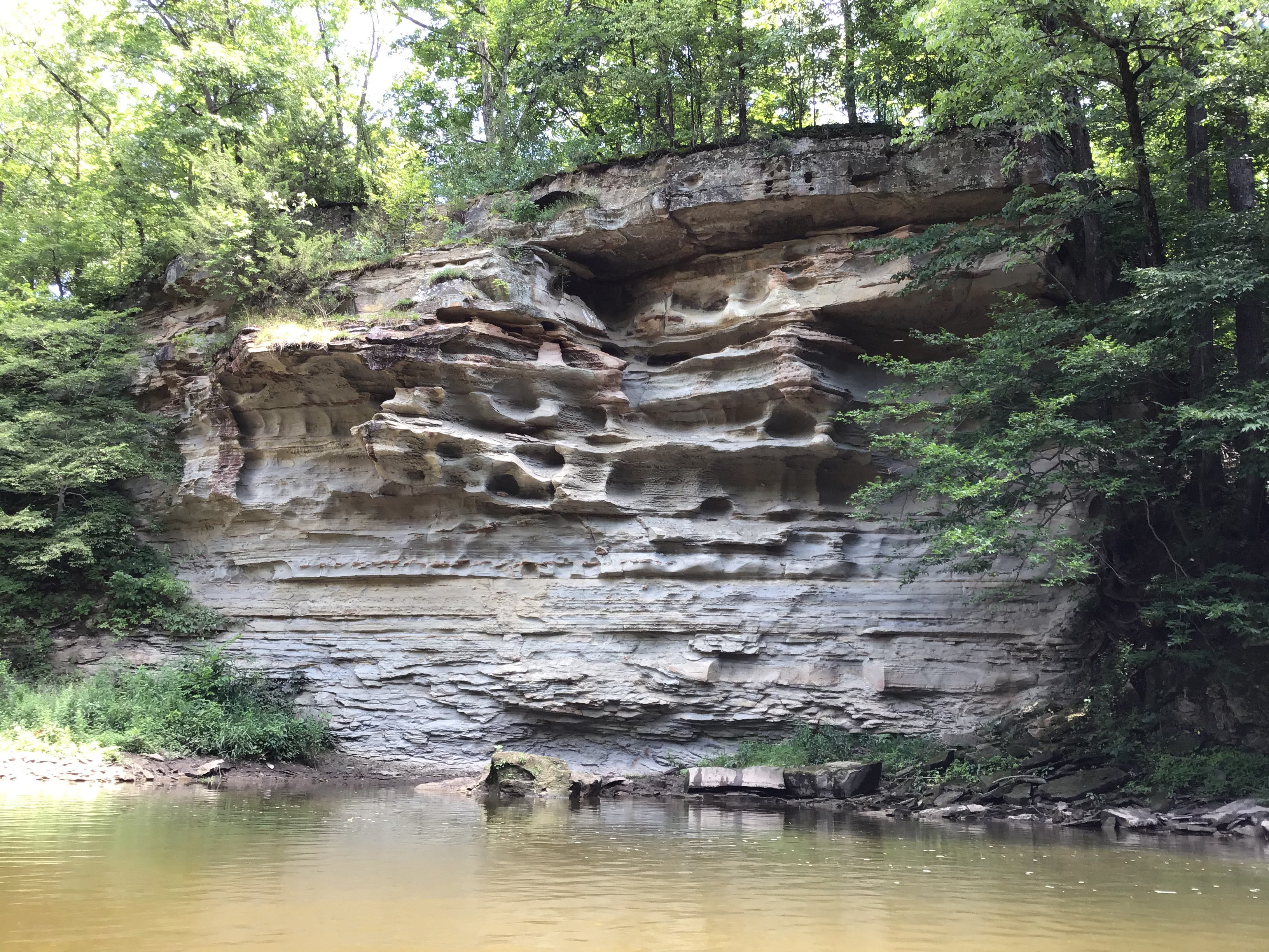 Sandstone bluffs next to creek.