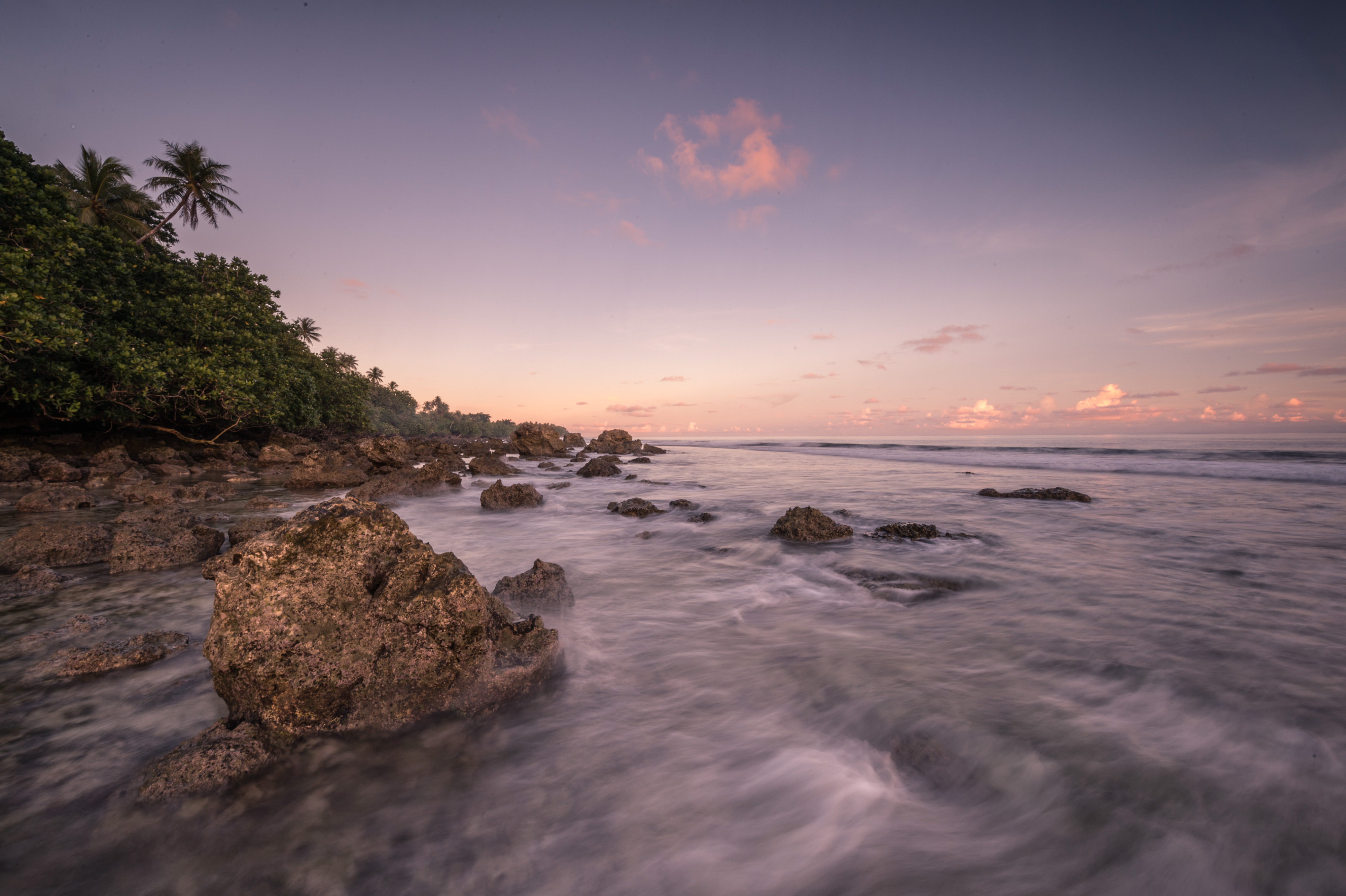 A view of the coastline at sunset near the village of Utwe on the island of Kosrae in Micronesia. 