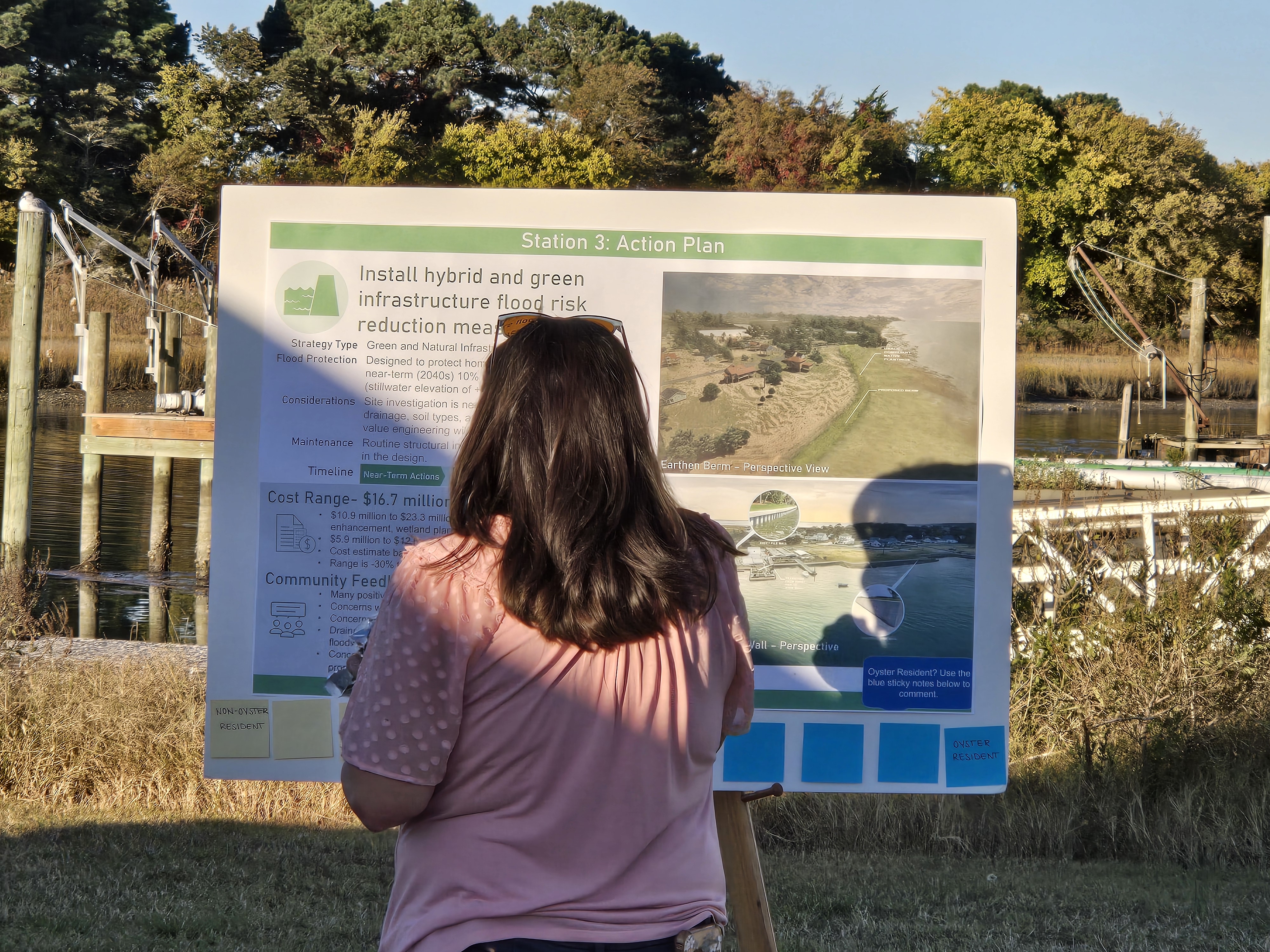 A community member looks at the action plan for making the Town of Oyster more resilient to sea-level rise.
