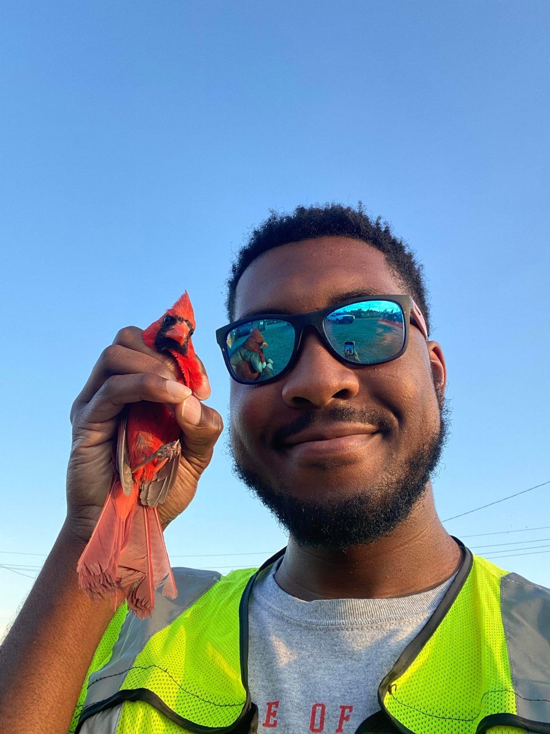 Derrick Mason holding a cardinal.