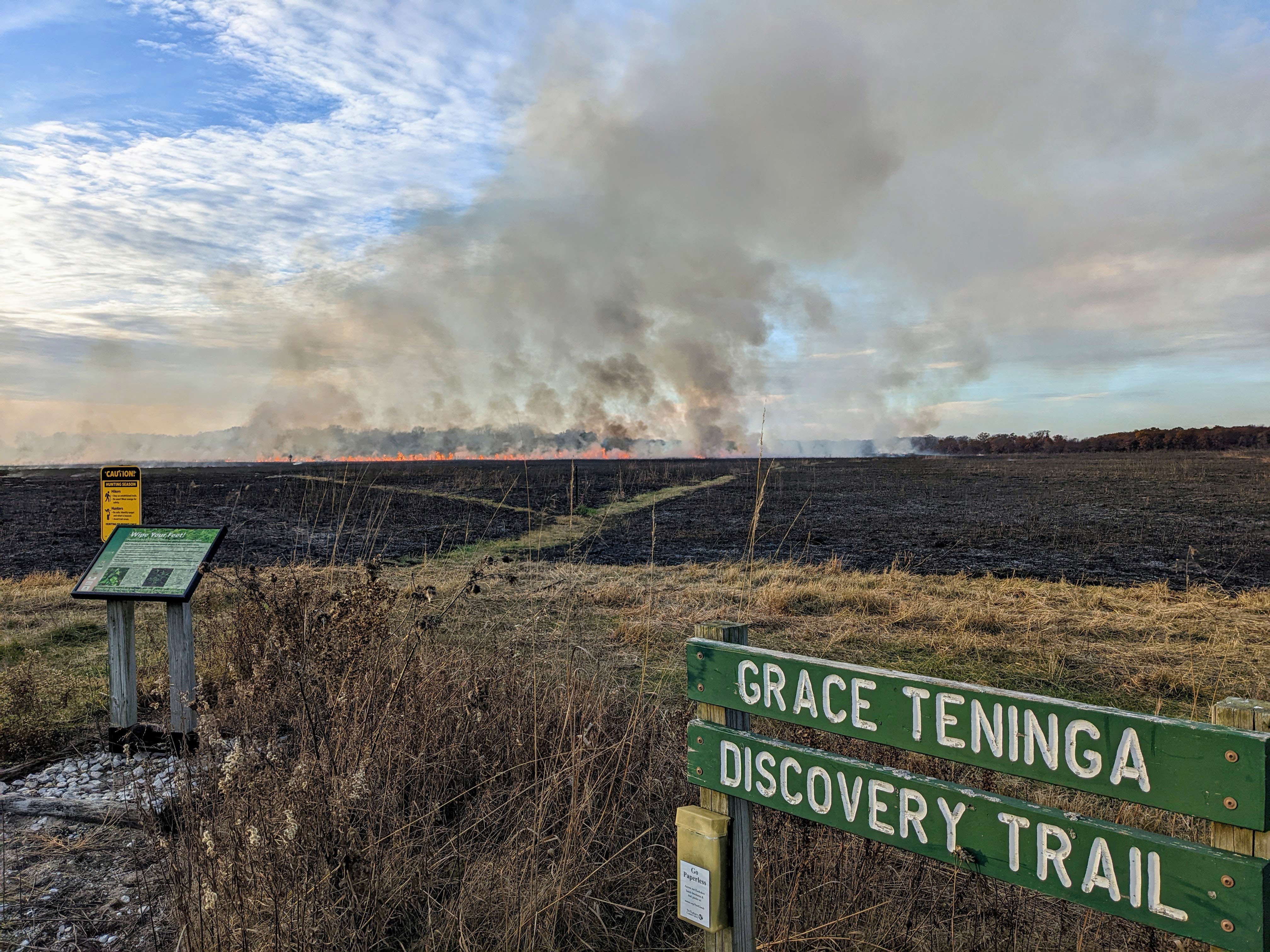 Prescribed fire at Kankakee Sands, with the Grace Teninga Discovery Trail sign in foreground.