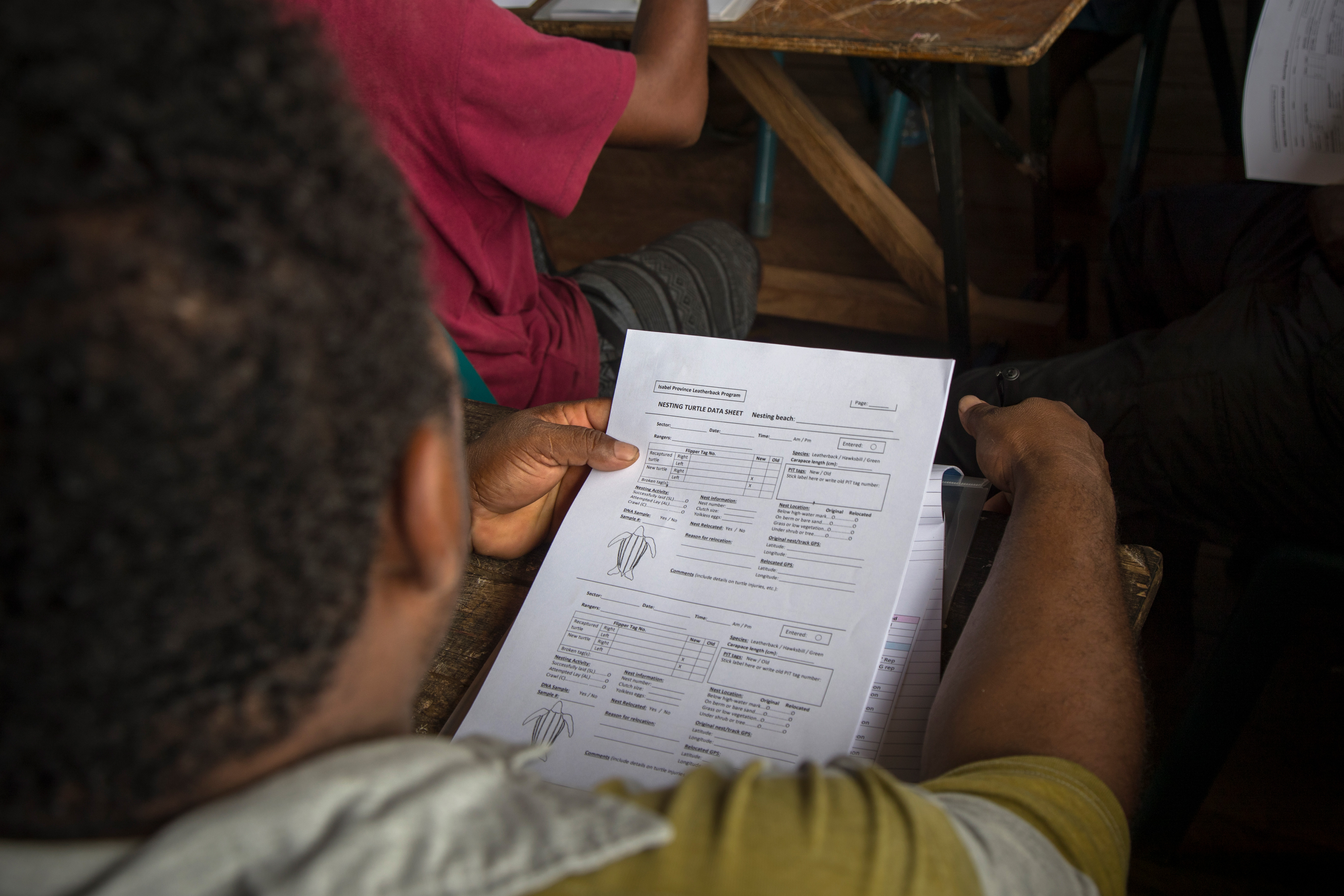 Potential rangers examine a data collection sheet at the training. 