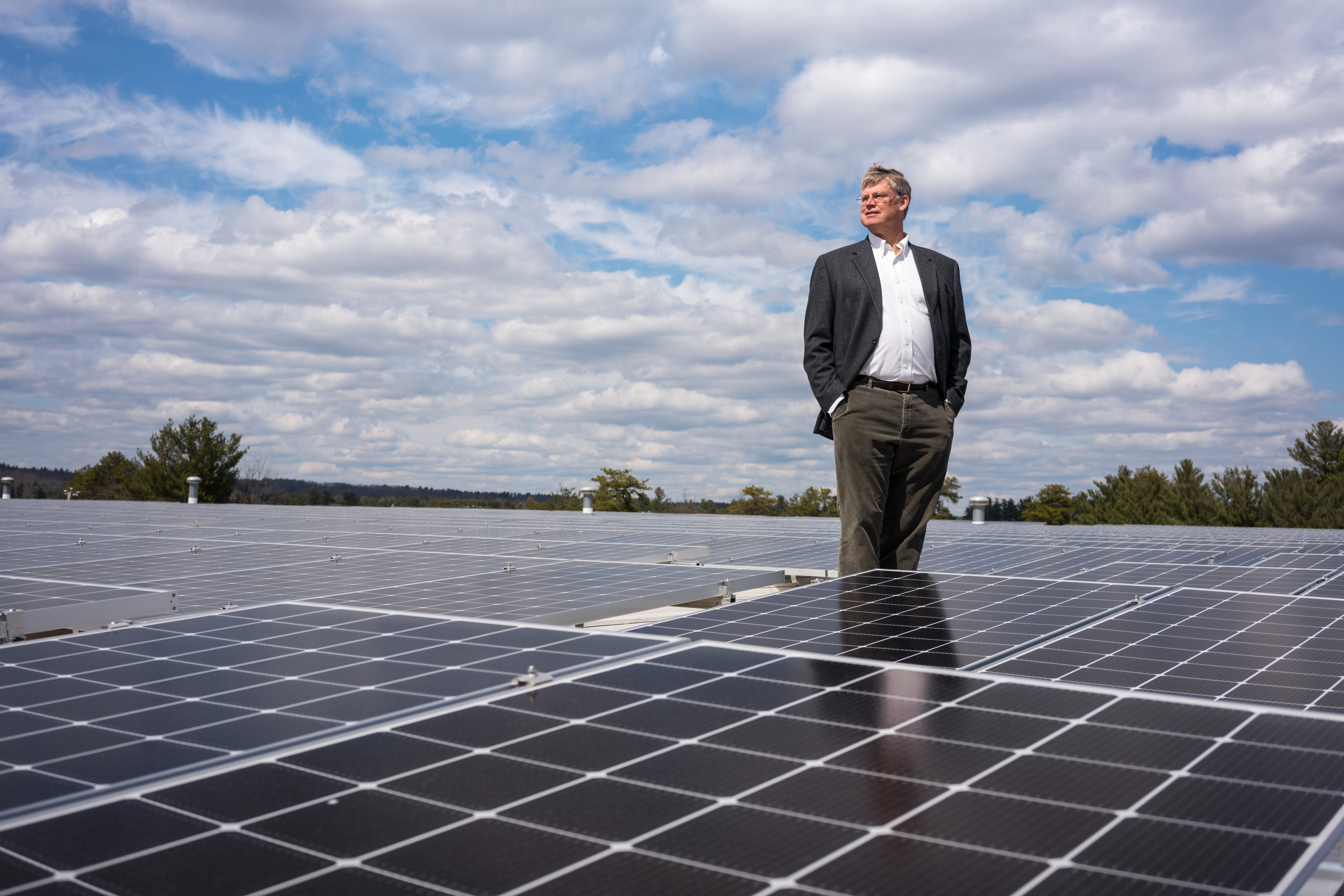 David Worthen stands among solar panels on the roof of Worthen Industries.
