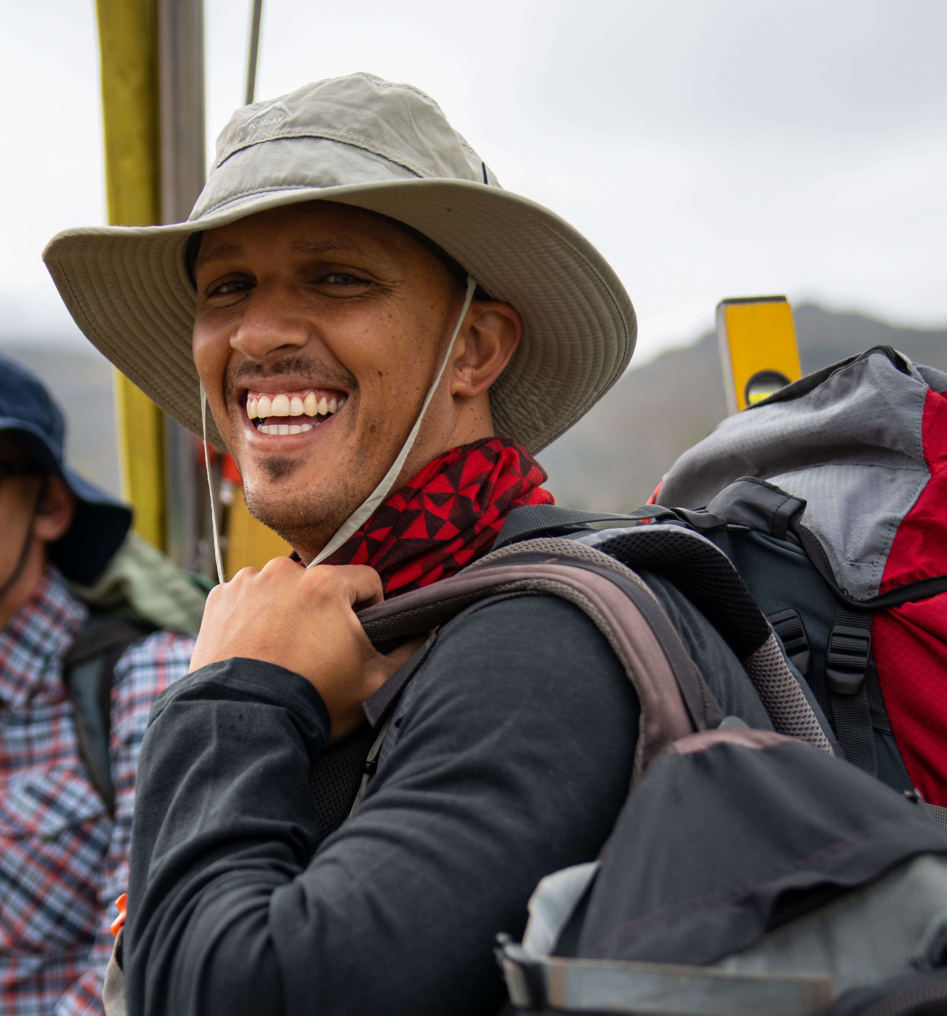 Man with backpack looking at camera