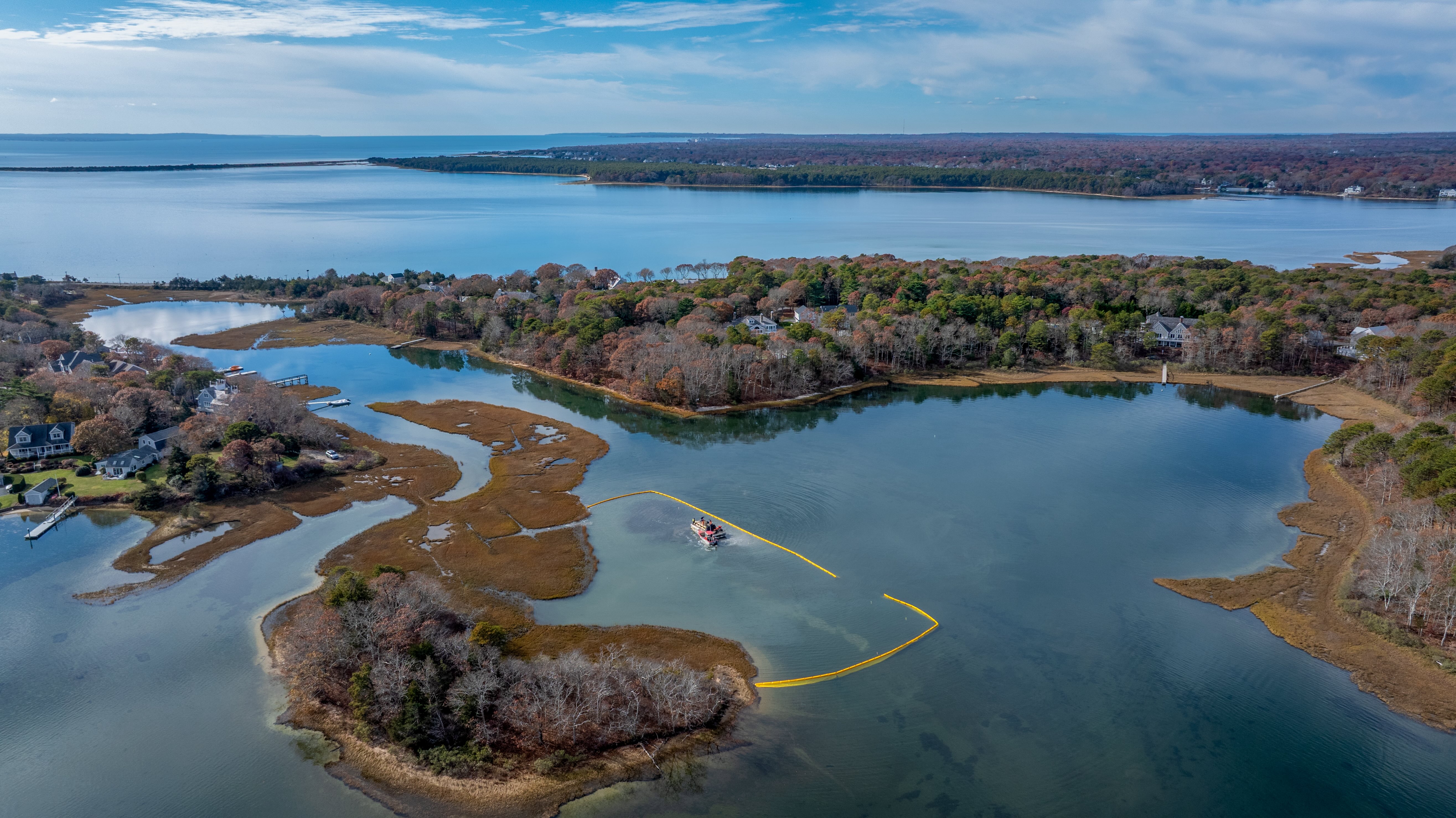 Surf clam shells being deposited into a section of Hamblin Pond in Mashpee to build the base for a wild oyster reef. 