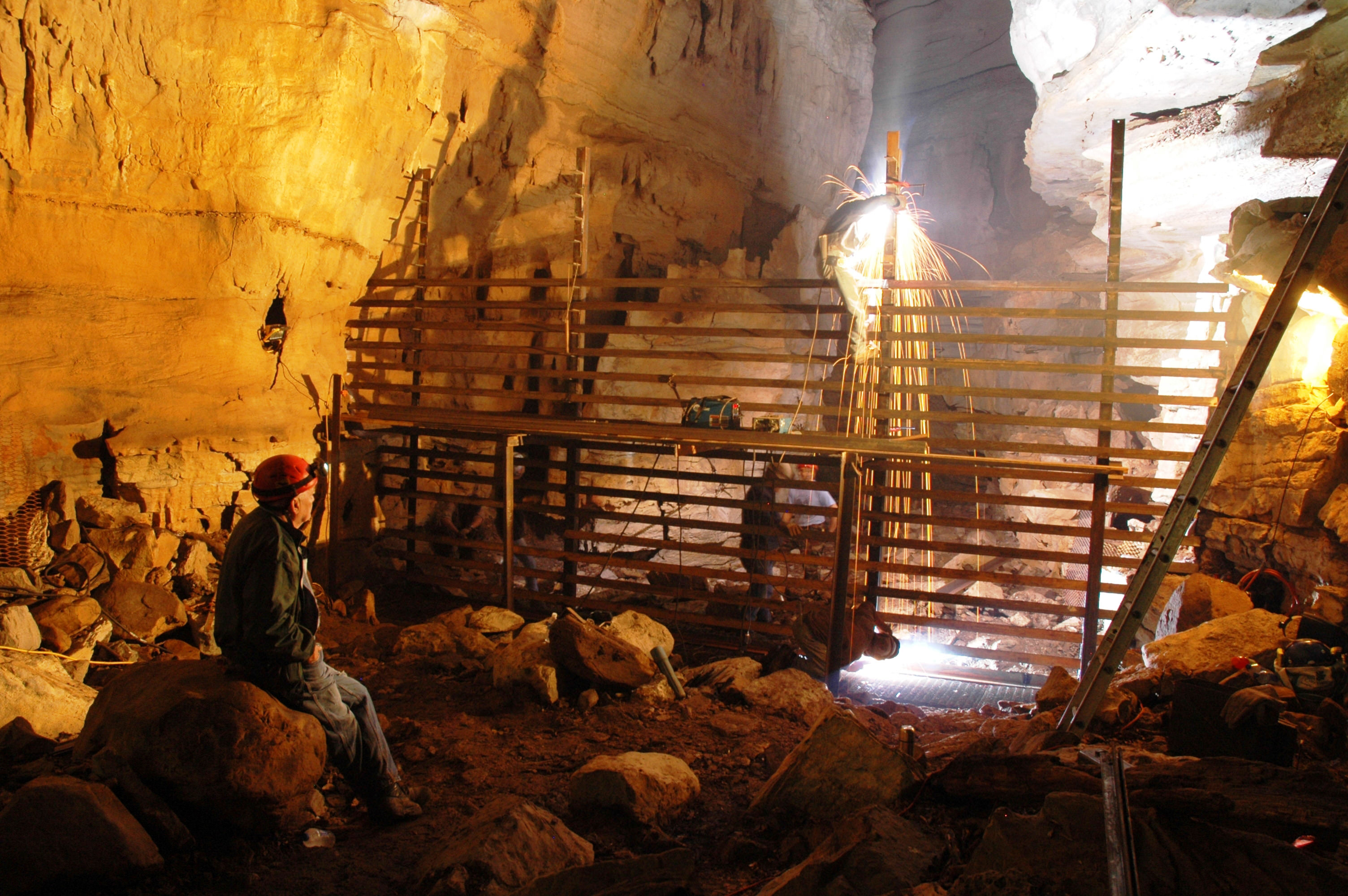 A gate divides part of a cave.