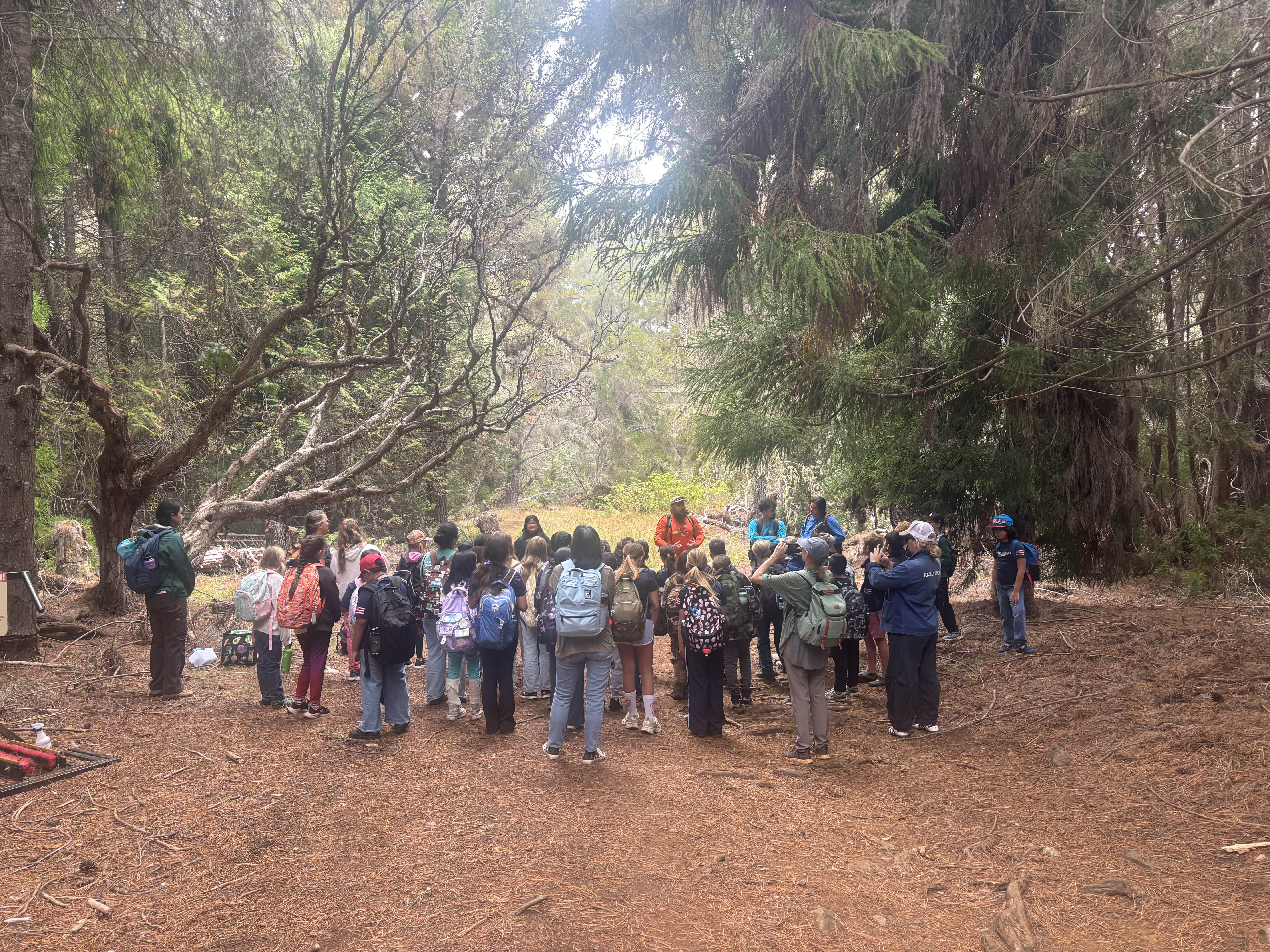A group of children on a field trip looking away from the camera.