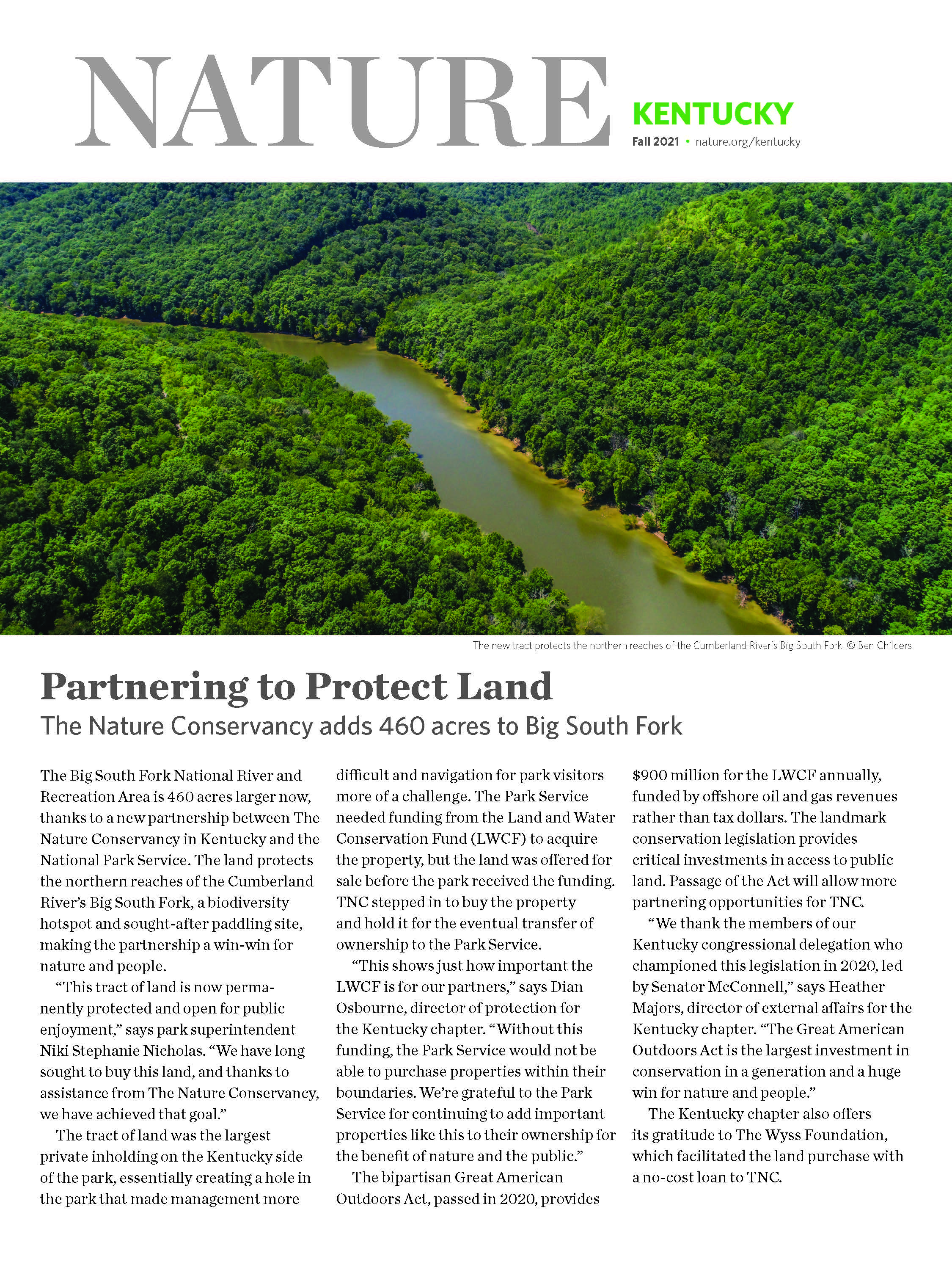 Magazine insert with photo of forest and river at top.