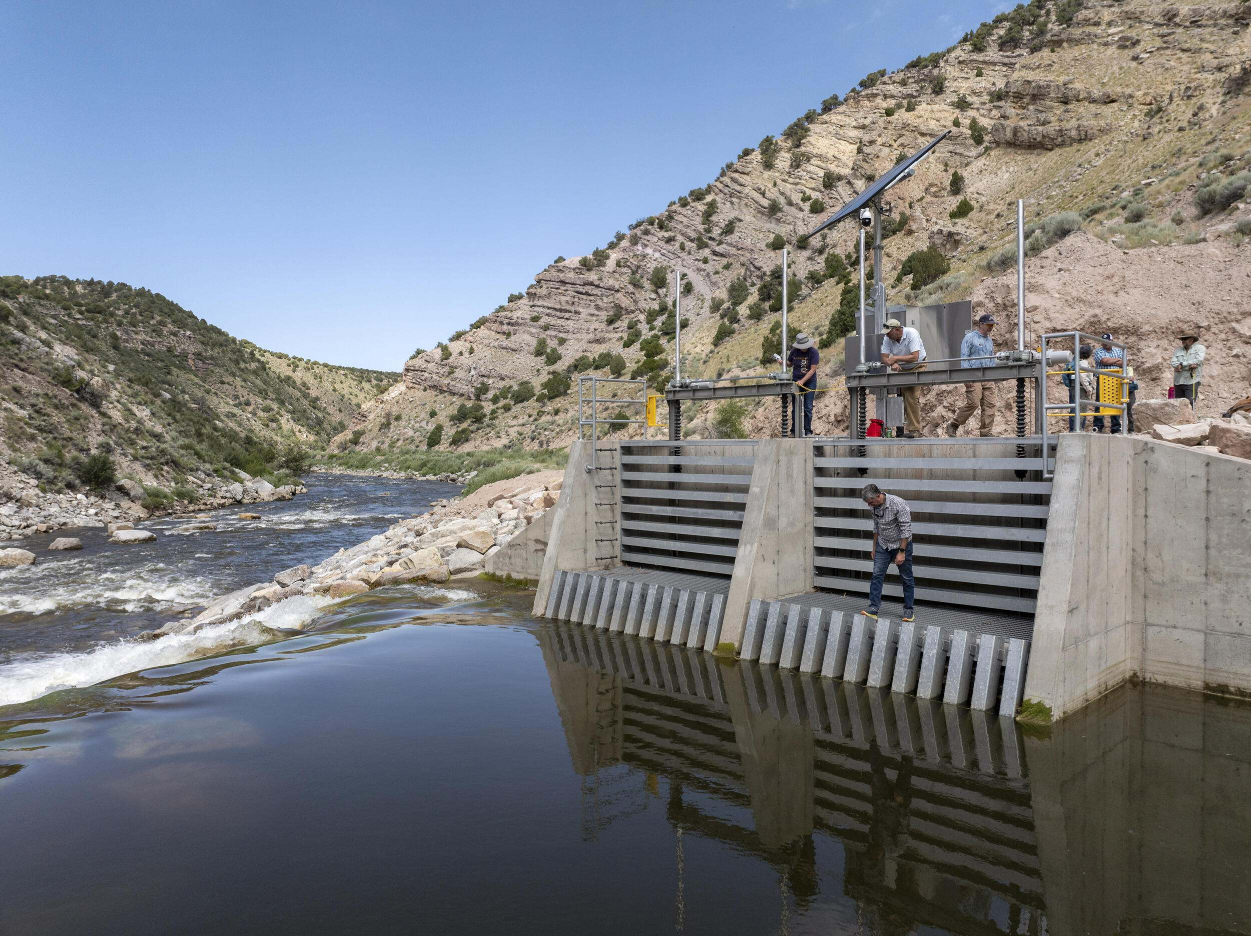 A group examines a water control structure.