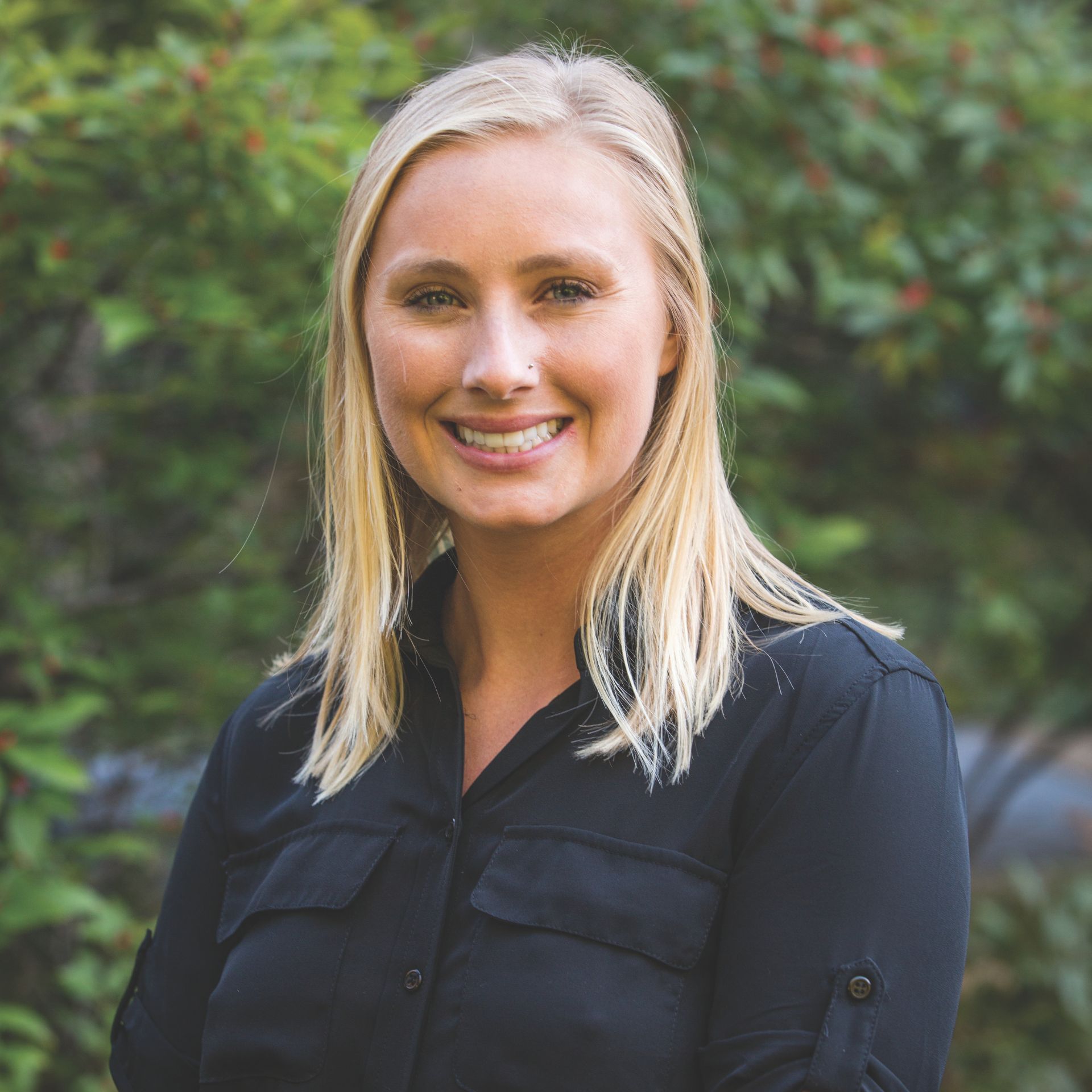 A headshot of Myrilla Hartkopf. She has long blond hair and is wearing a dark blue shirt.