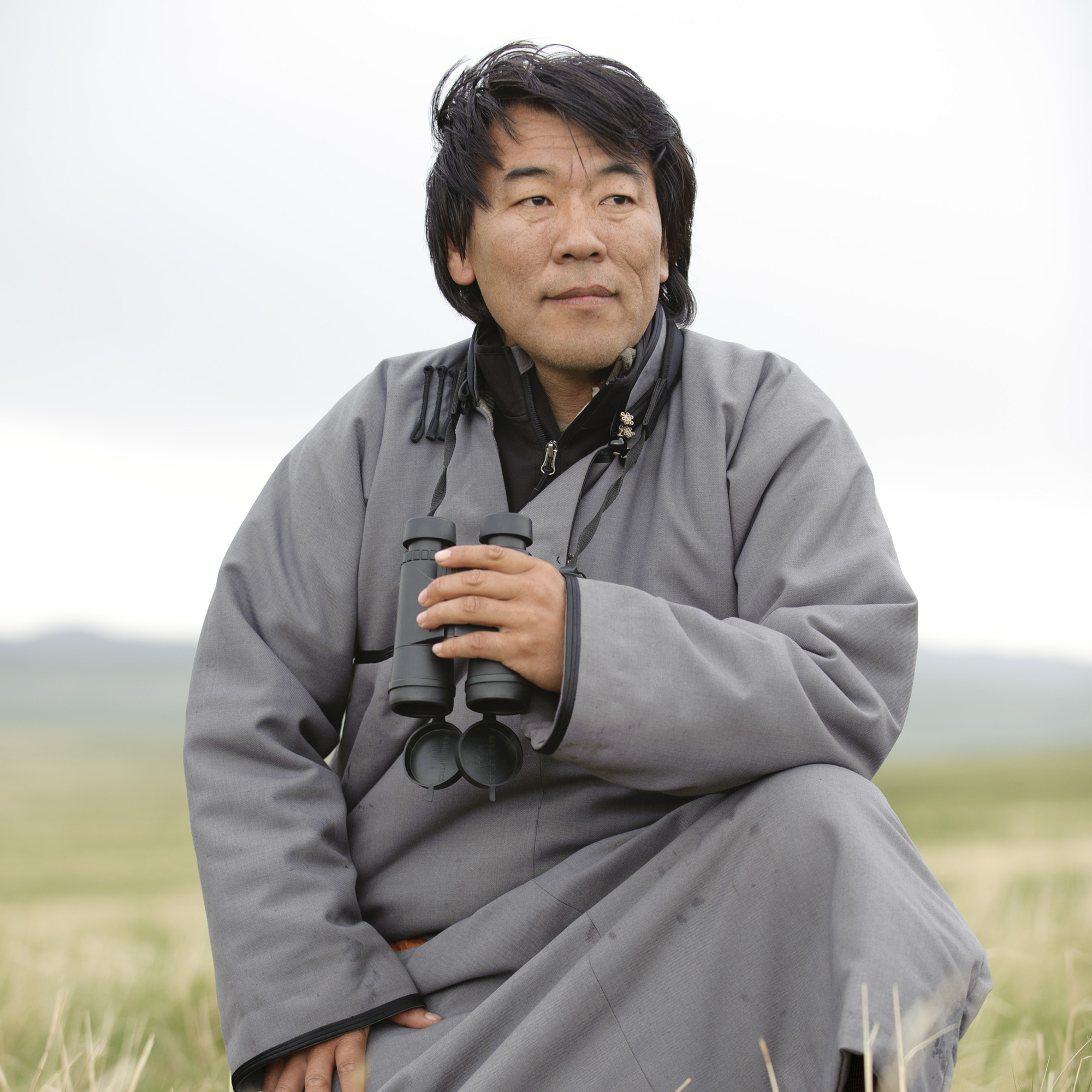 close up portrait of man outside holding binoculars