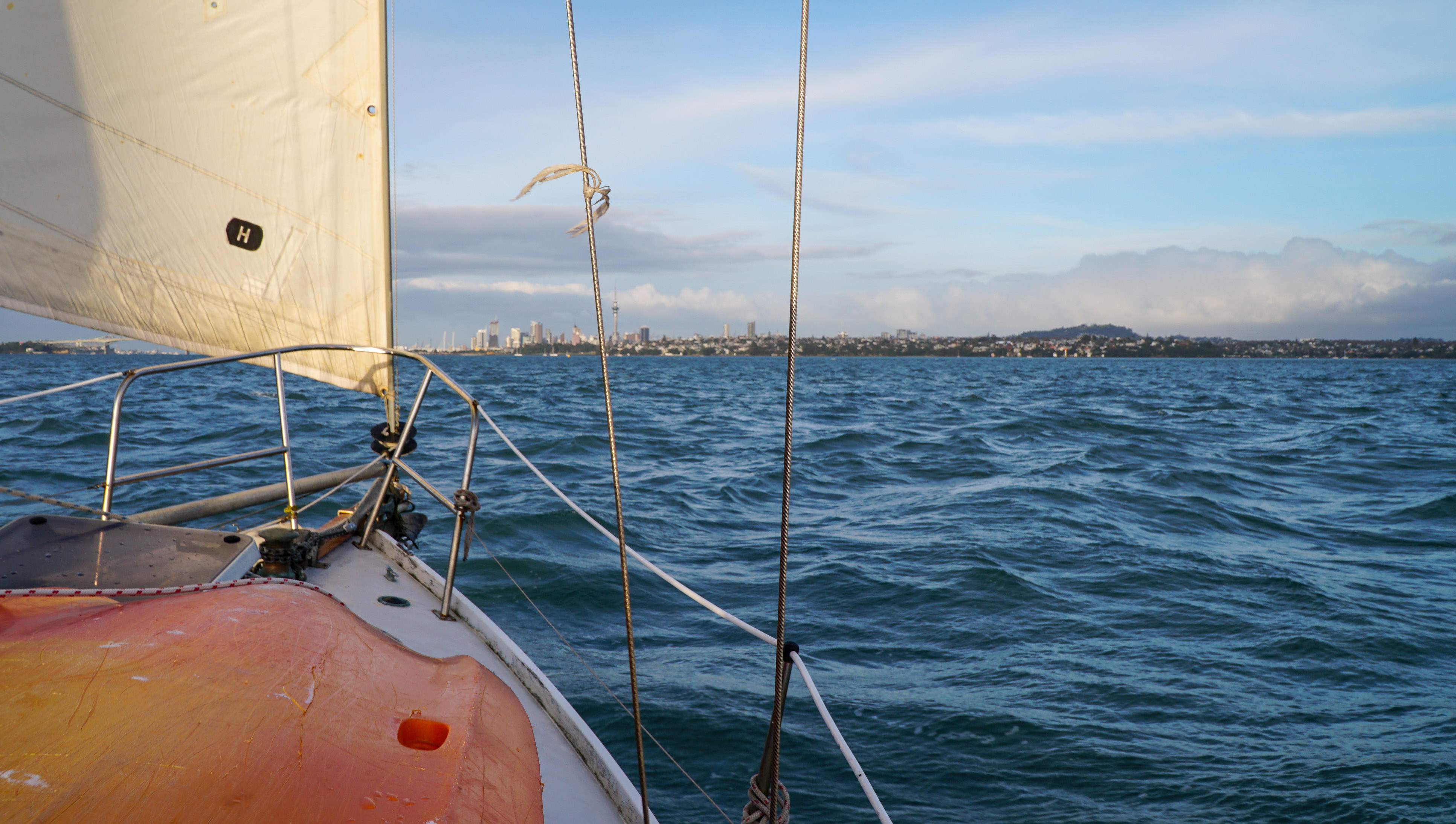 View from a sailboat in a harbor.