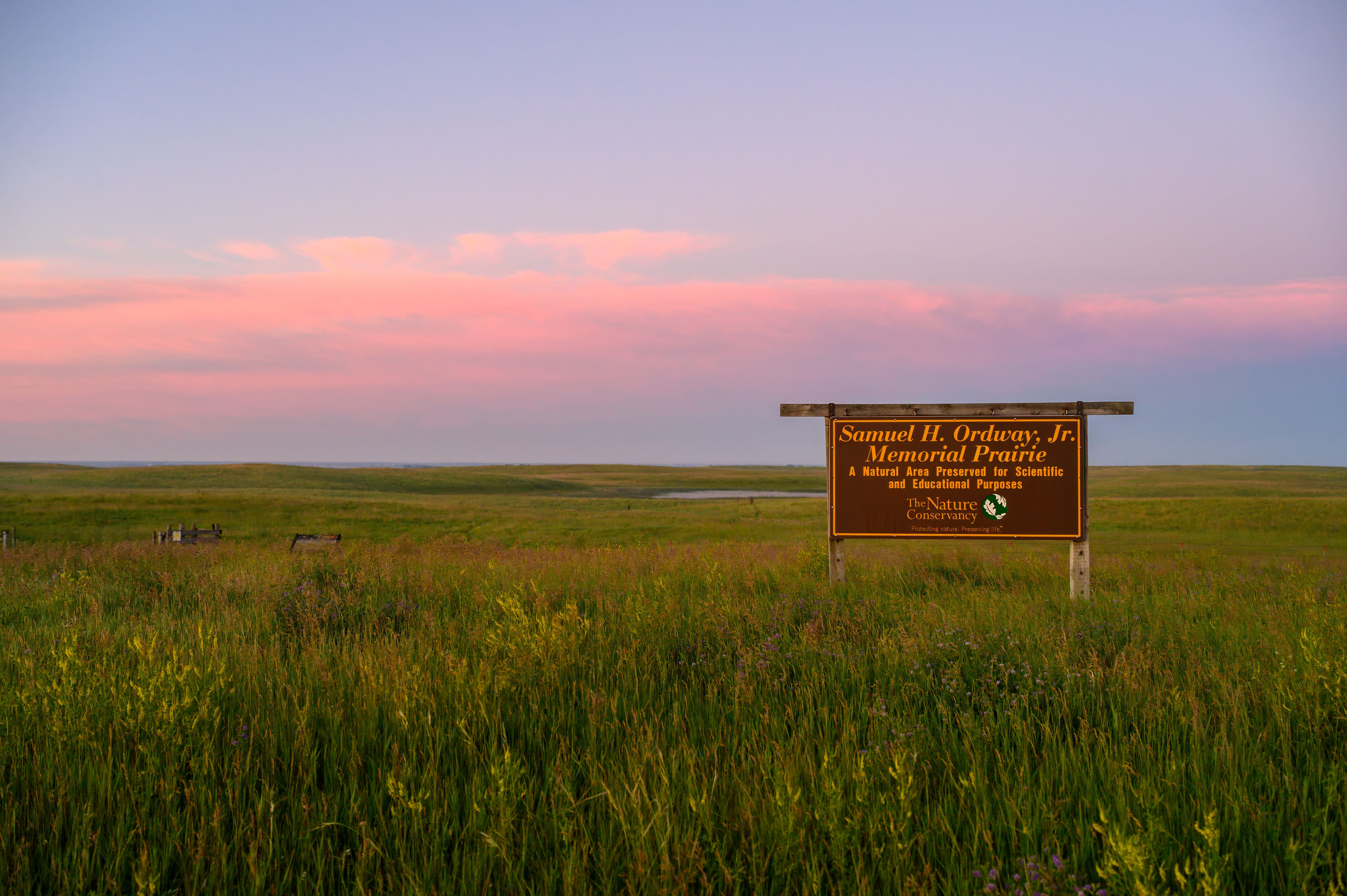 Sunset over a sign in the prairie.
