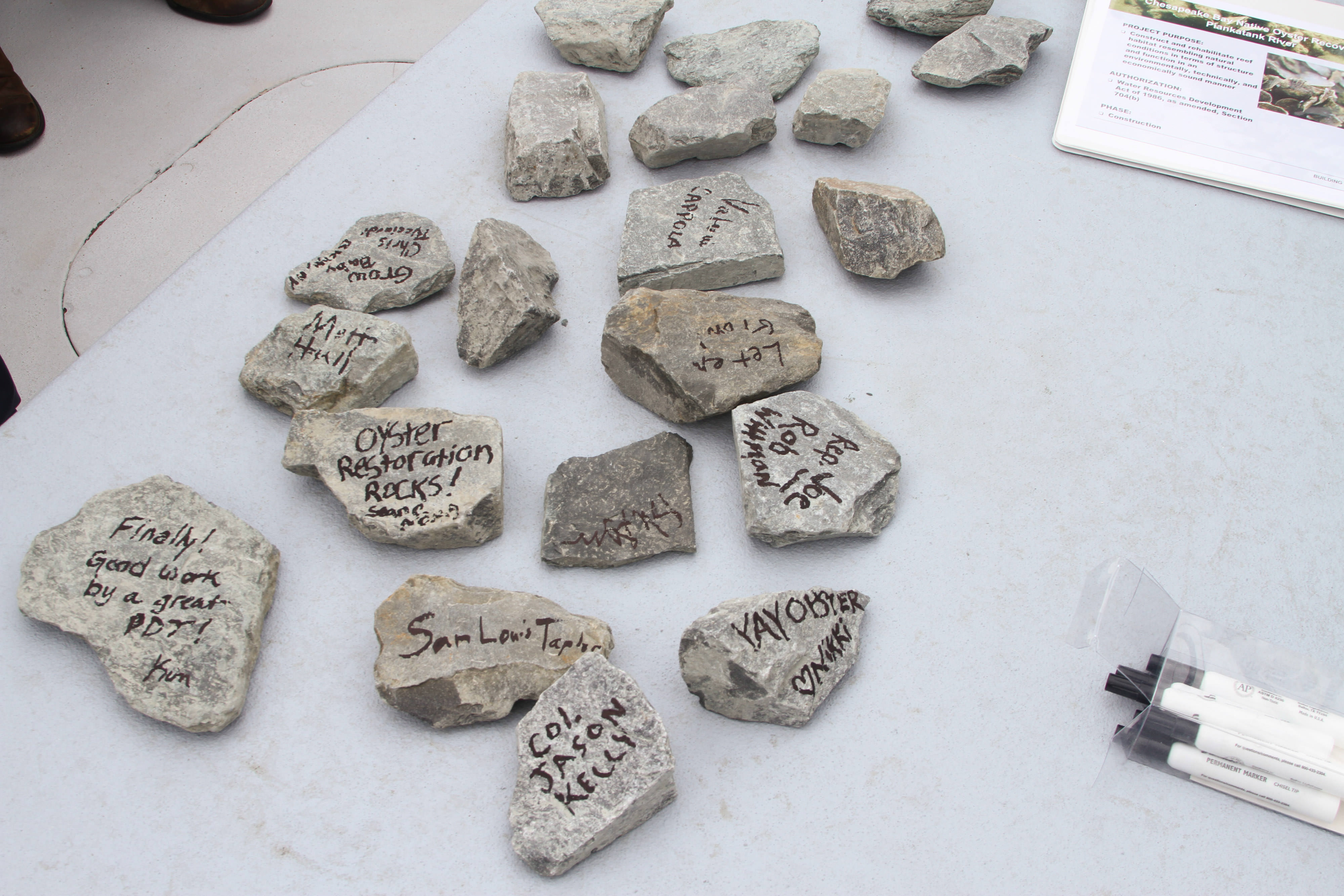 Collection of rocks with phrases celebrating oyster reef restoration projects.