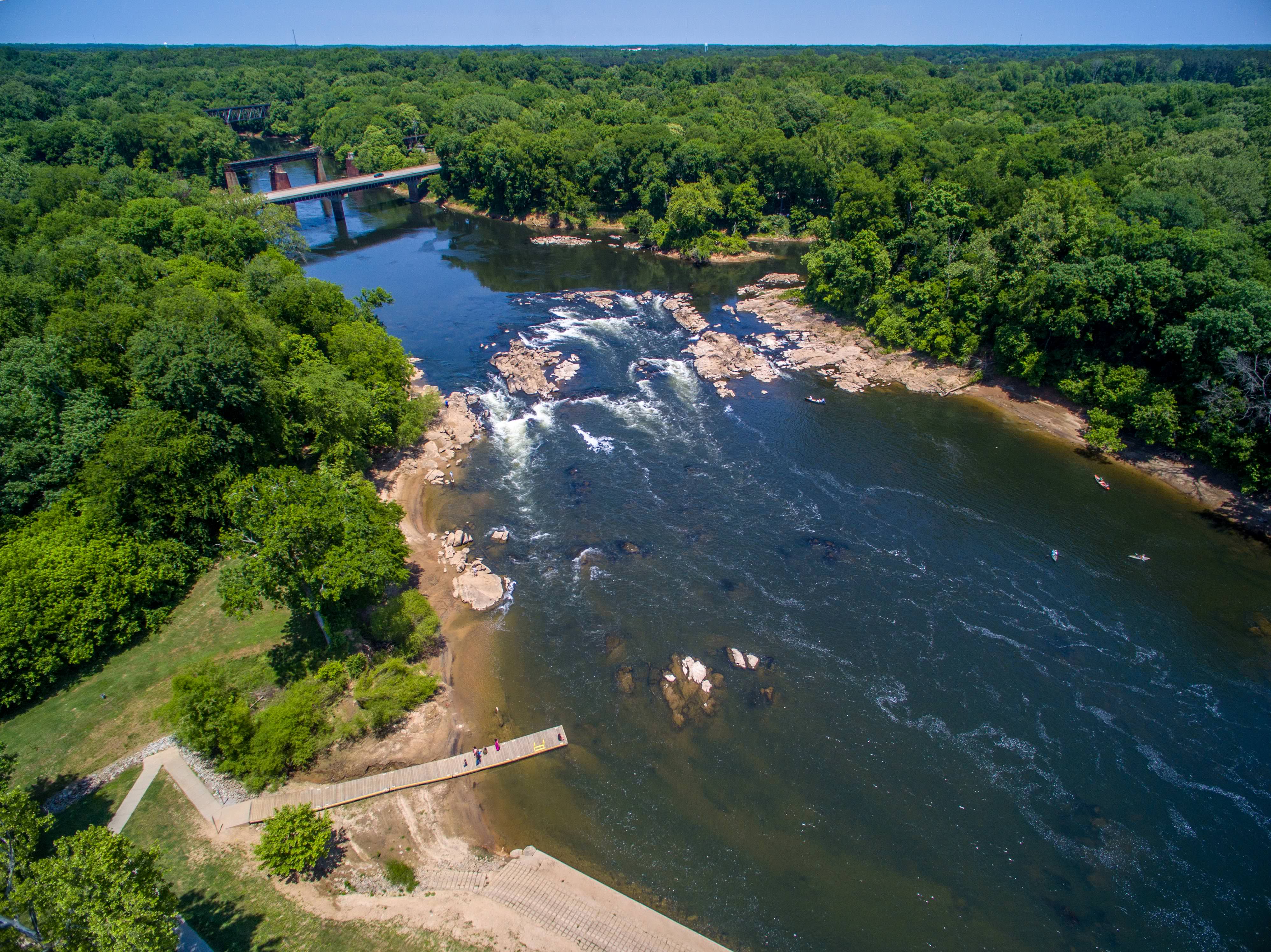 A photo of the Roanoke River and rapids, surrounded by forests.