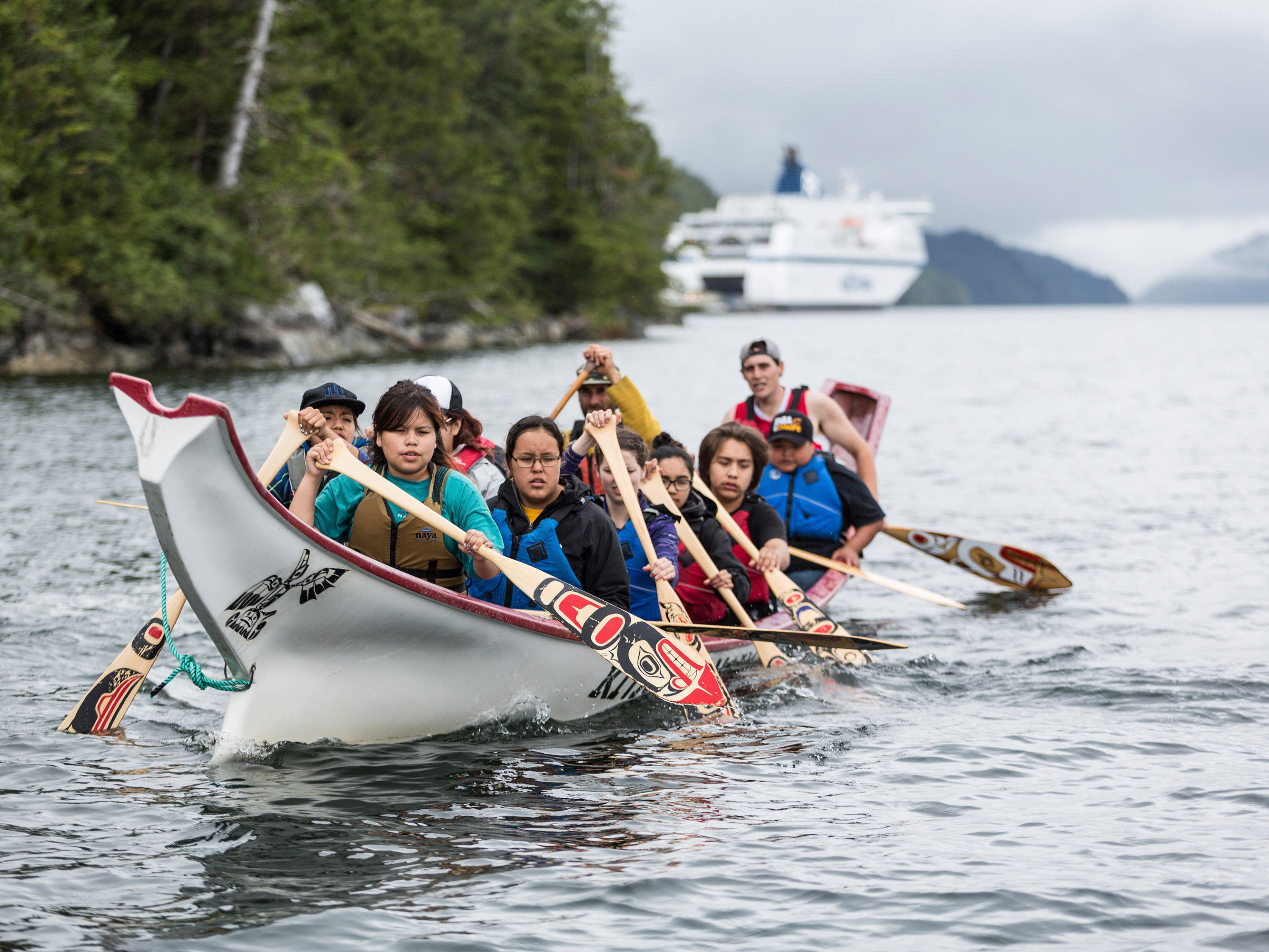 Students paddle a traditional canoe near Klemtu, Canada