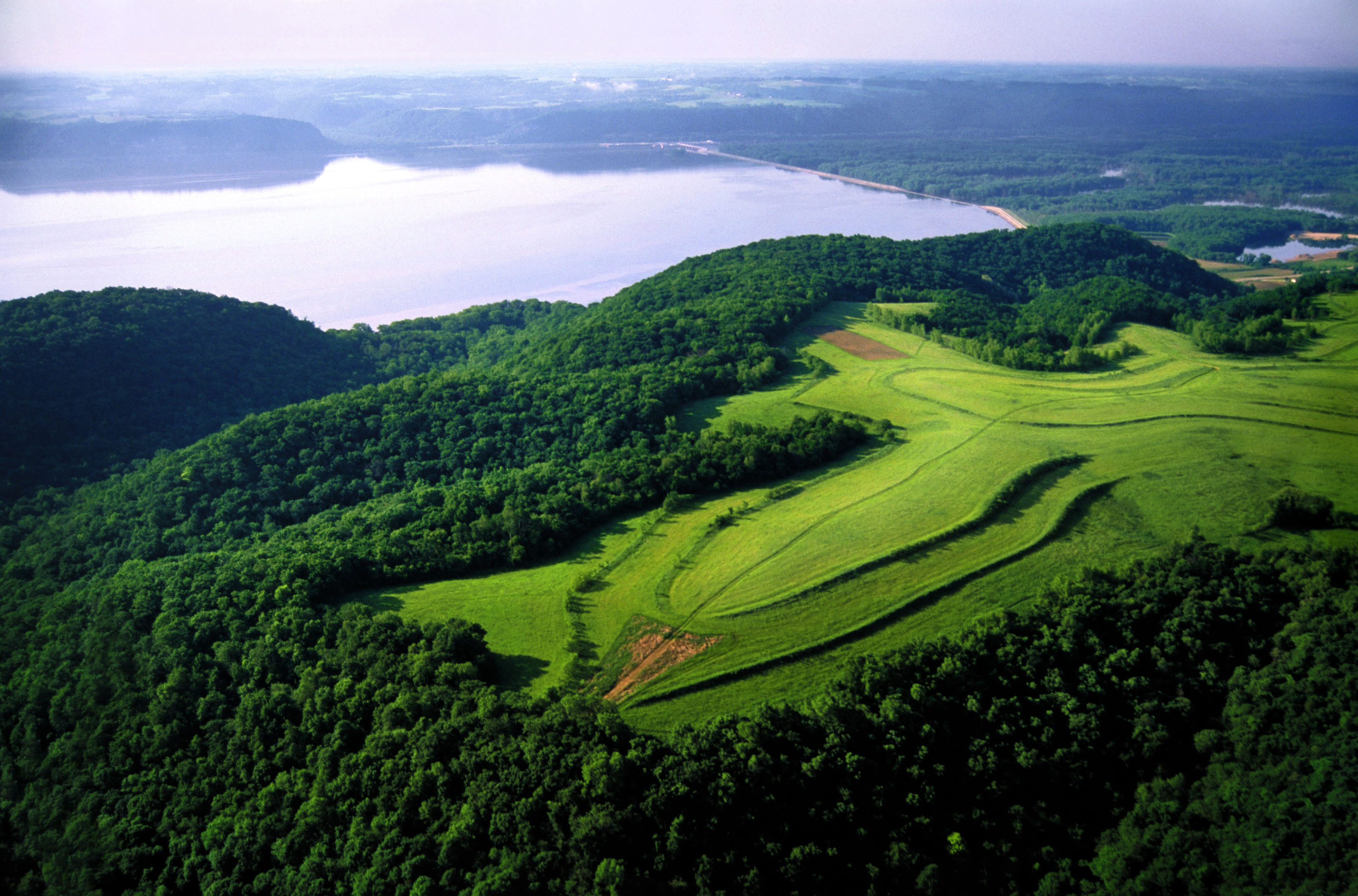 Overlooking the Mississippi River with wooded floodplain and agriculture fields. 