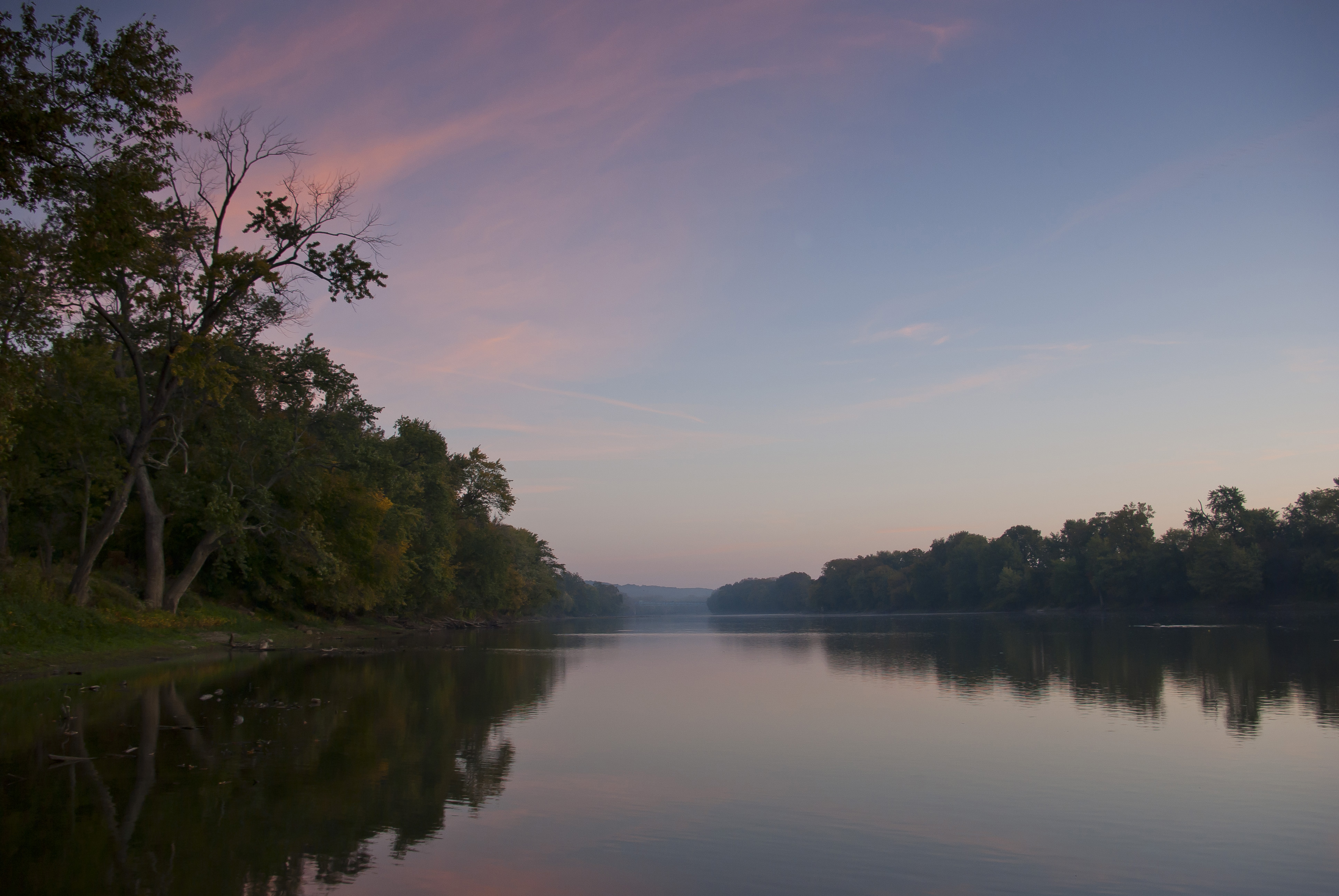 A view of the flat Wabash River during sunset.