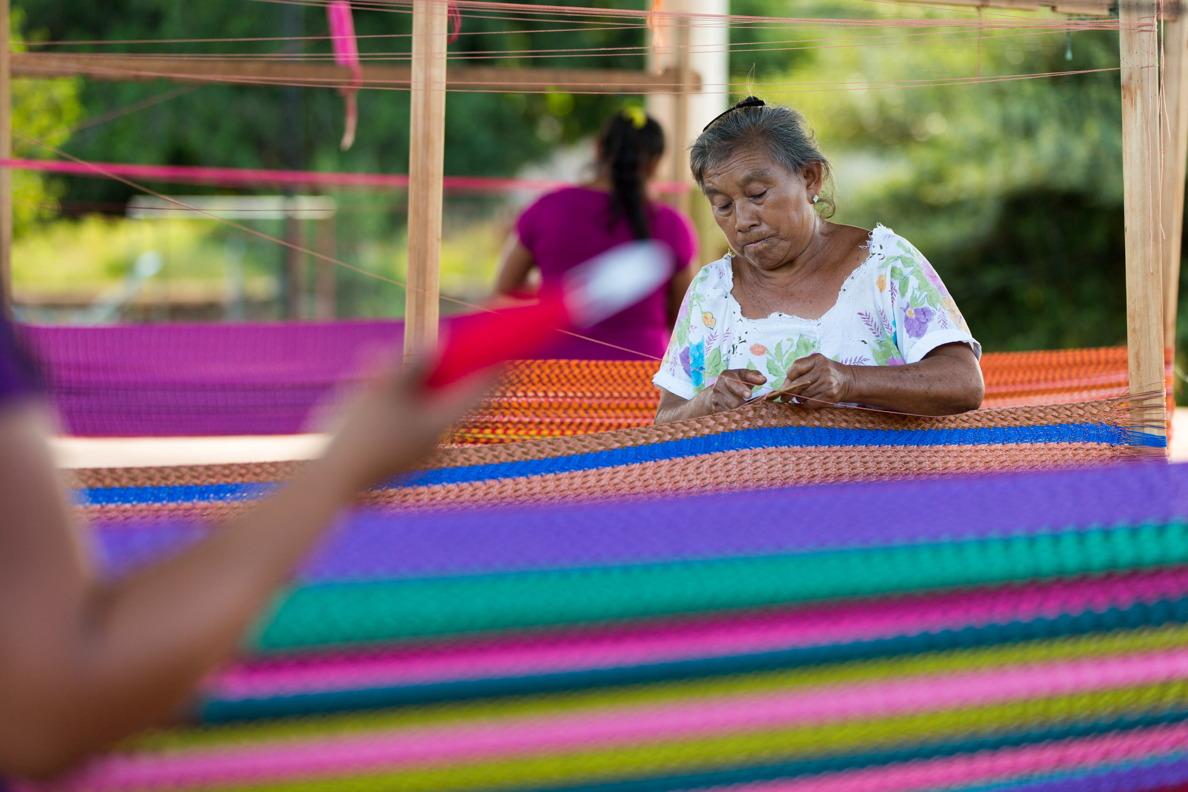 Woman weaving traditional Mayan hammock.