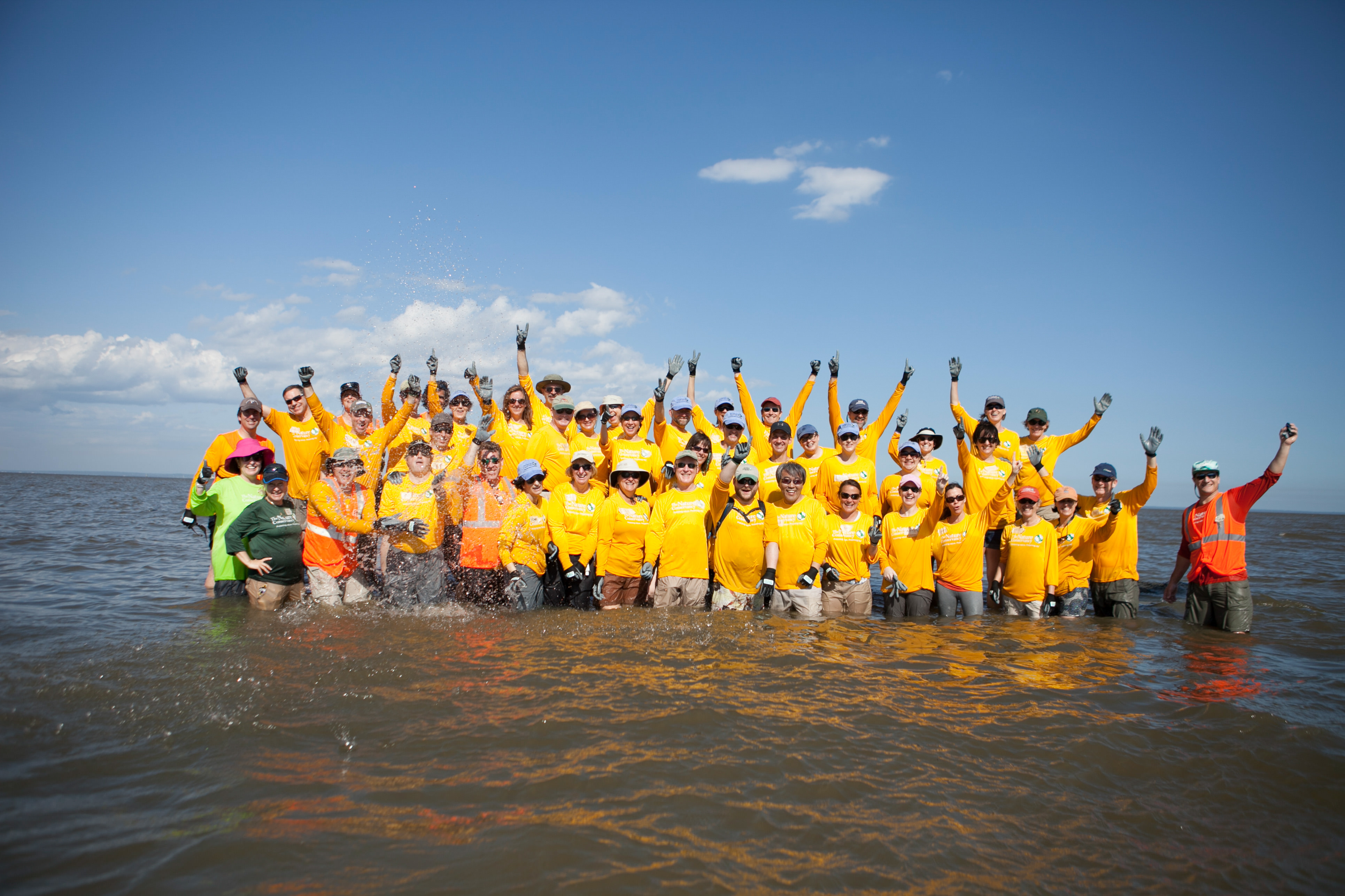 TNC Senior Leaders work together to build five reef structures at Arlington Cove in Mobile Bay, Alabama