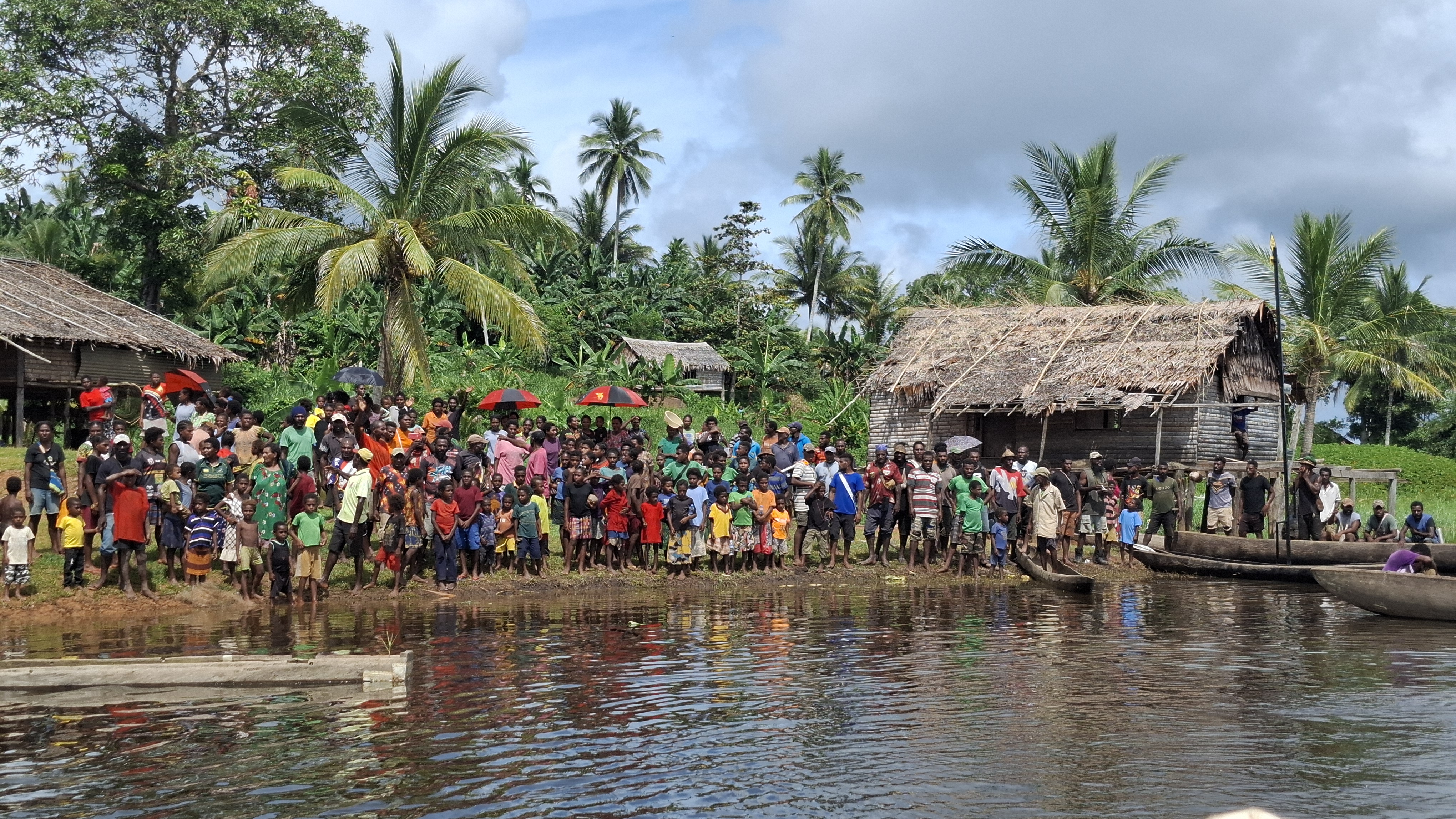People standing next to a river.